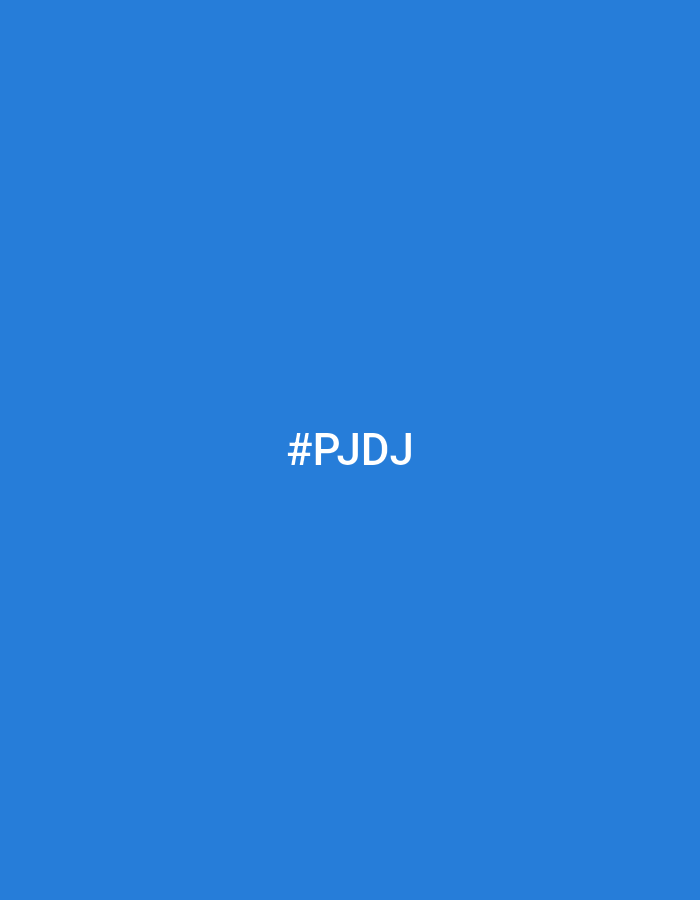 The image displays a solid, vibrant blue background. Centered horizontally on this blue field, the white text "#PJDj" is visible. The font is a sans-serif typeface, appearing clear and distinct against the background. There are no people, objects, or specific environmental features depicted within the image itself. The scene is located in Lhokseumawe, Indonesia.