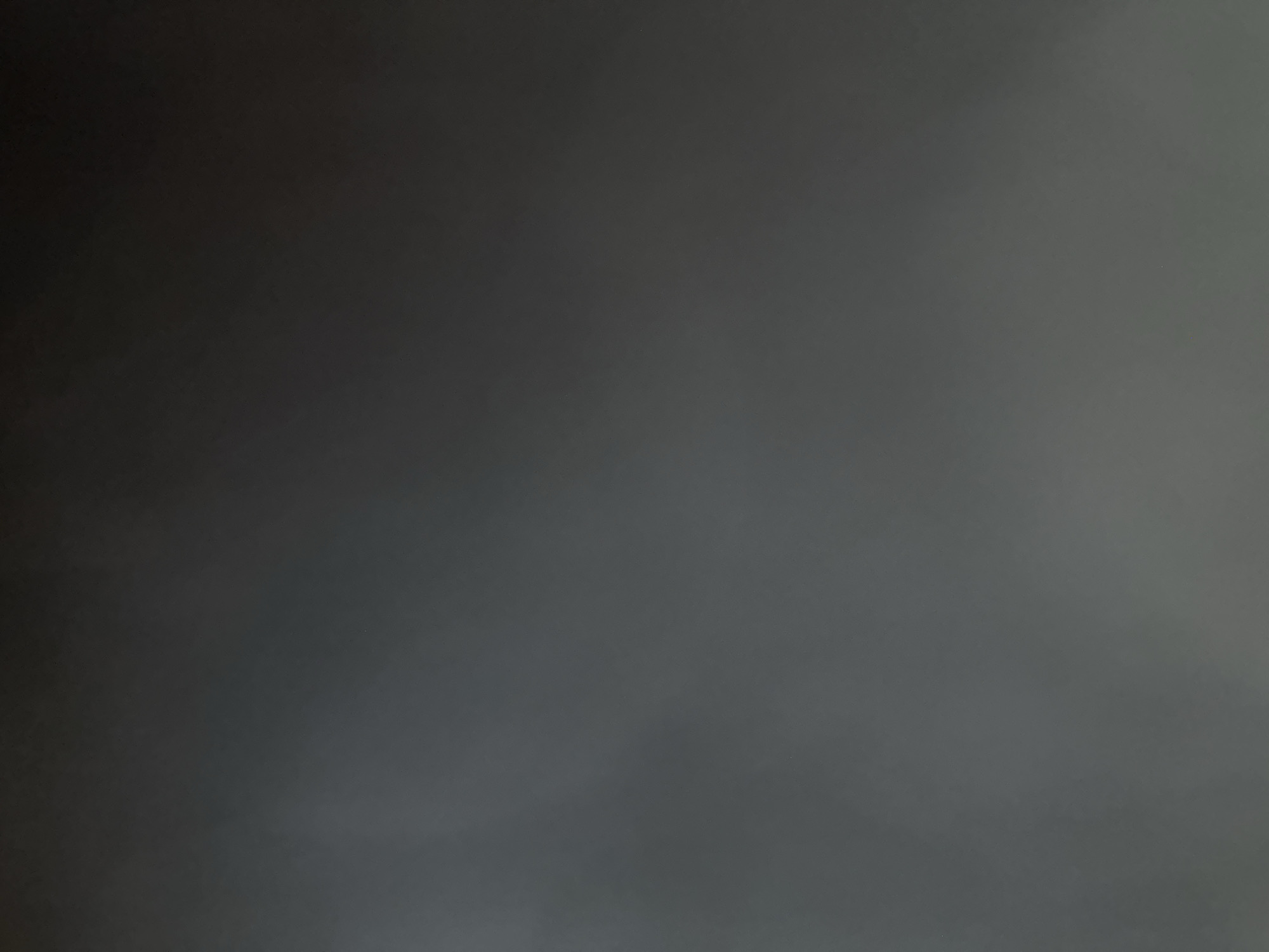 The image is a blurry, dark photograph with no discernible objects or people. It is impossible to determine the location, time, or any other details about the scene.