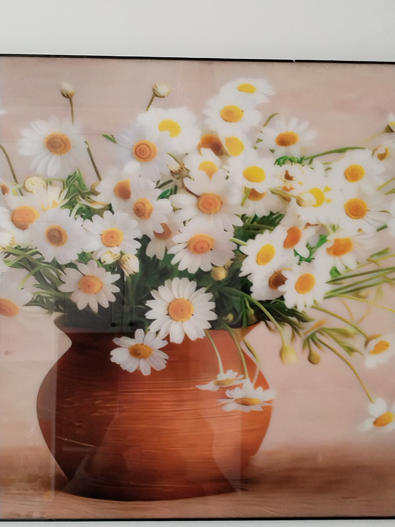 This is a painting of a bouquet of daisies in a terra cotta vase. The daisies are white with yellow centers, and some are in full bloom while others are still buds. The vase is a warm, earthy brown and has a textured surface with horizontal lines. The background is a soft, muted pink and brown, giving the painting a gentle and serene feel. There are no people or discernible city elements present in the image. The scene appears to be a still life arrangement.