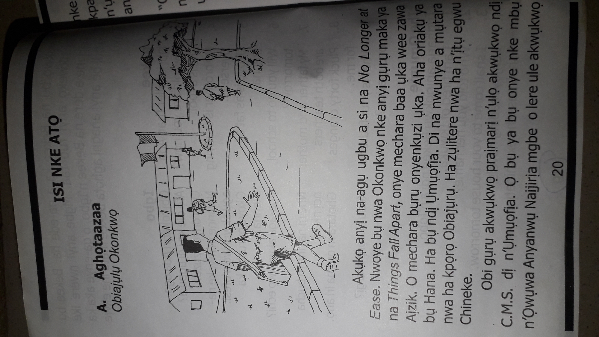 This media file depicts a scene from a book, likely a children's educational text, with illustrations and text in Igbo. The illustration shows a street scene with several people and buildings, including what appears to be a school. In the foreground, a person is sitting on a bench with a book, while another person walks away. In the background, there are more figures, possibly students, near a school building. A tree stands to the left of the scene. The text is predominantly in Igbo and appears to be a narrative or educational passage. There is a page number "20" visible at the bottom right. The text includes the title "ISI NKE ATO" and a name "A. Aghotaazaa Obiajulu Okonkwo". The phrase "No Longer at Ease" is also visible, suggesting a literary connection. The overall impression is an illustration accompanying an educational or literary text in a Nigerian context.