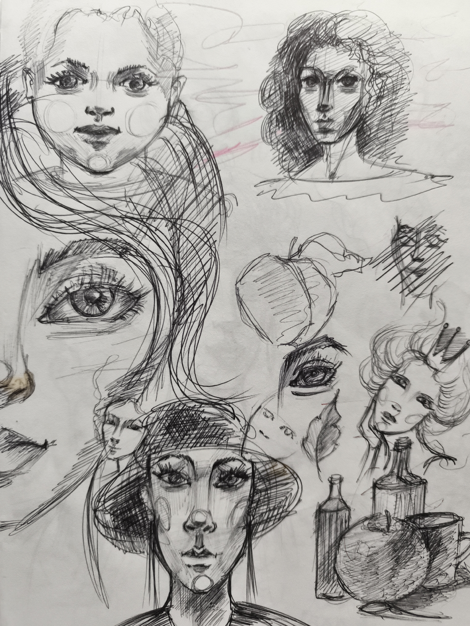 The image is a black and white pencil sketch on paper, featuring a collage of various drawings. The subjects are primarily portraits of women and girls, depicted in different styles and poses, some with elaborate hairstyles and facial expressions. There are also drawings of still life elements, including apples, bottles, and a mug. Additionally, there are abstract lines and shapes scattered throughout the composition. The sketch appears to be a collection of studies or a mood board rather than a single cohesive scene. The location in the city of Saint-Denis, France is not identifiable from the artwork.