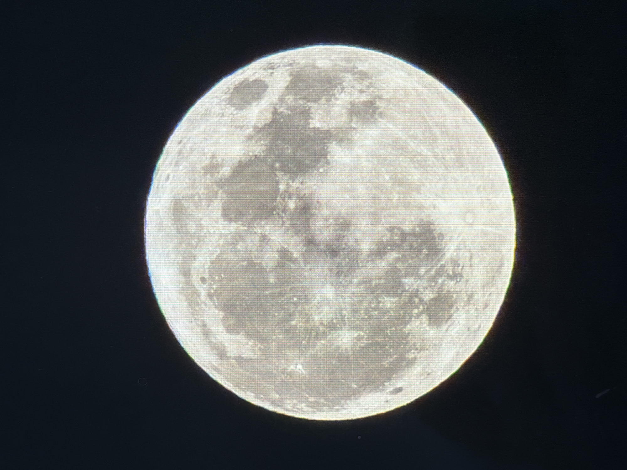 The image is a close-up, high-resolution photograph of the full moon against a black night sky. The moon's surface is clearly visible, showing craters, maria (dark, basaltic plains), and highlands. The overall lighting suggests it is illuminated by the sun. There are no visible objects or people in the image. The image does not contain any contextual information related to the city of Kyiv, Ukraine, or any specific location.