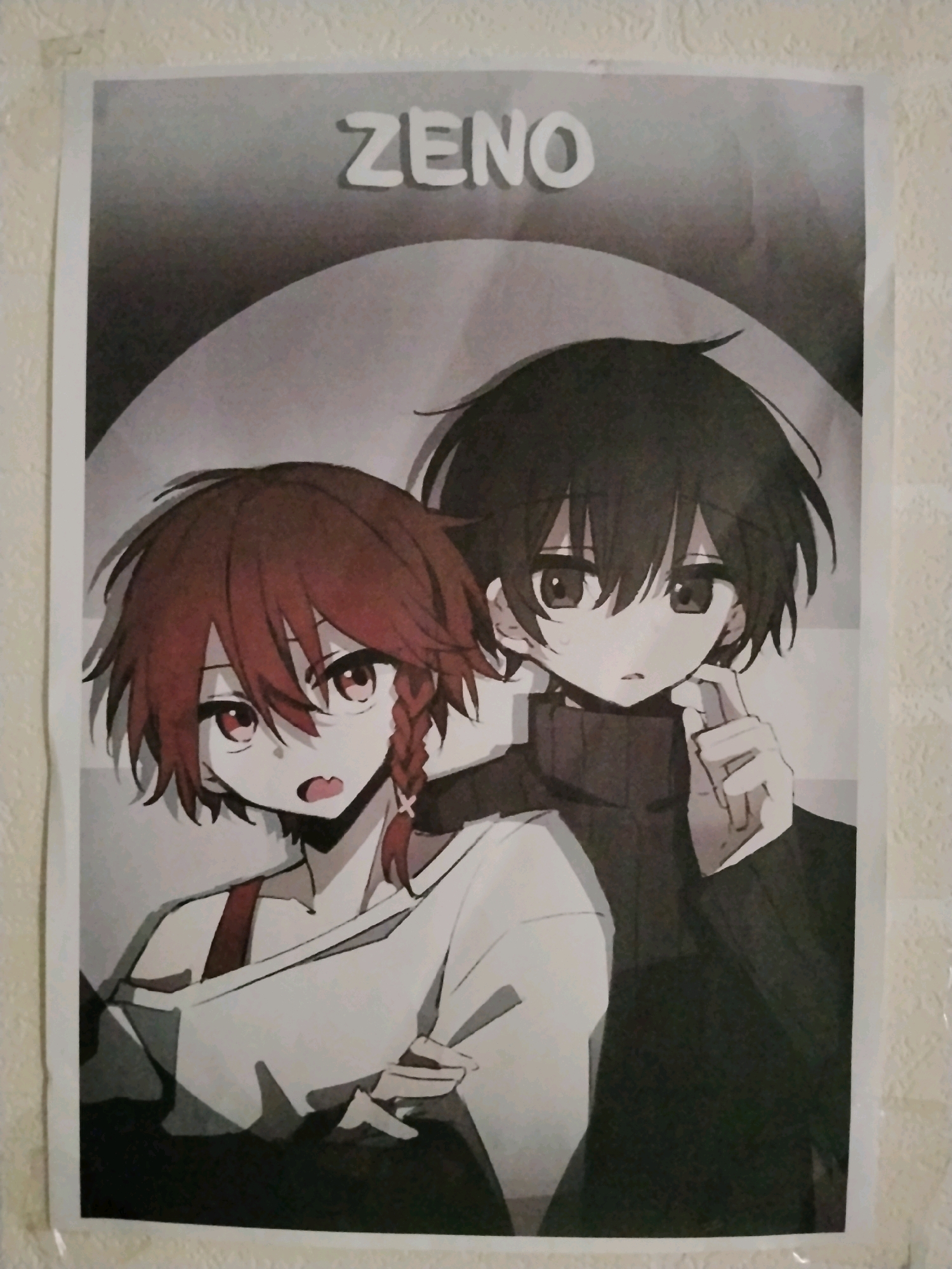 The image is a photograph of a poster featuring anime-style characters. The poster has a title at the top that reads "ZENO". There are two characters depicted: one with reddish-brown hair in a braid and another with dark hair. Both characters have large eyes. The poster appears to be hung on a textured wall, possibly wallpaper, in an indoor setting. The lighting suggests it is not a professional studio shot, and there are slight shadows and reflections visible on the poster and wall. The exact location within Yogyakarta, Indonesia cannot be determined from the image itself.