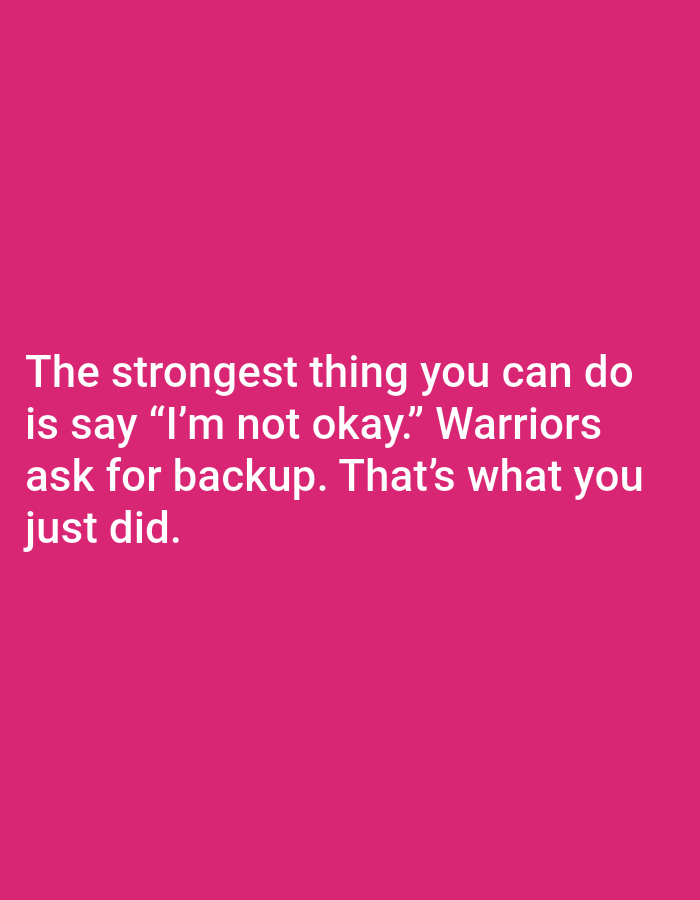 The image is a close-up, eye-level shot of a pink background with white text. The text reads: "The strongest thing you can do is say 'I'm not okay.' Warriors ask for backup. That's what you just did." The text is centered on the image, with each phrase on a new line. There are no other objects, people, or environmental details visible in the image. The location in the city of Jauro Yinu, Nigeria, is not depicted or referenced in the image.