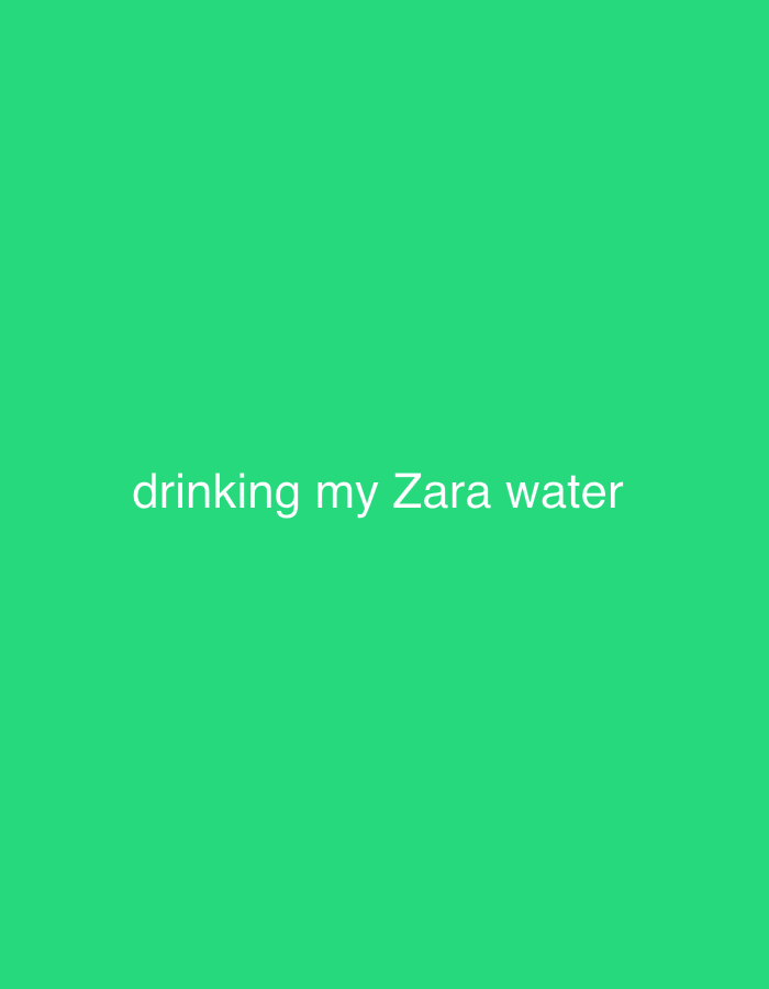 The image displays a solid, vibrant green background. There are no people, objects, or discernible activities visually depicted in the scene. The setting is monochromatic, offering no visual cues about a specific location, time of day, or weather. The only prominent detail is white text, centrally aligned, which reads: "drinking my Zara water". While the context indicates the location is Milan, Italy, the image itself does not provide any visual indication of this.