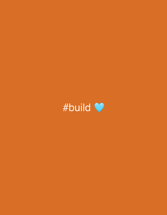 The image consists of a solid orange background. In the center of the image, there is the text "#build" in white, followed by a small, light blue heart emoji. The image does not contain any information related to the city of Ungasan, Indonesia, or any people, subjects, objects, actions, interactions, or environment that would relate to that location.