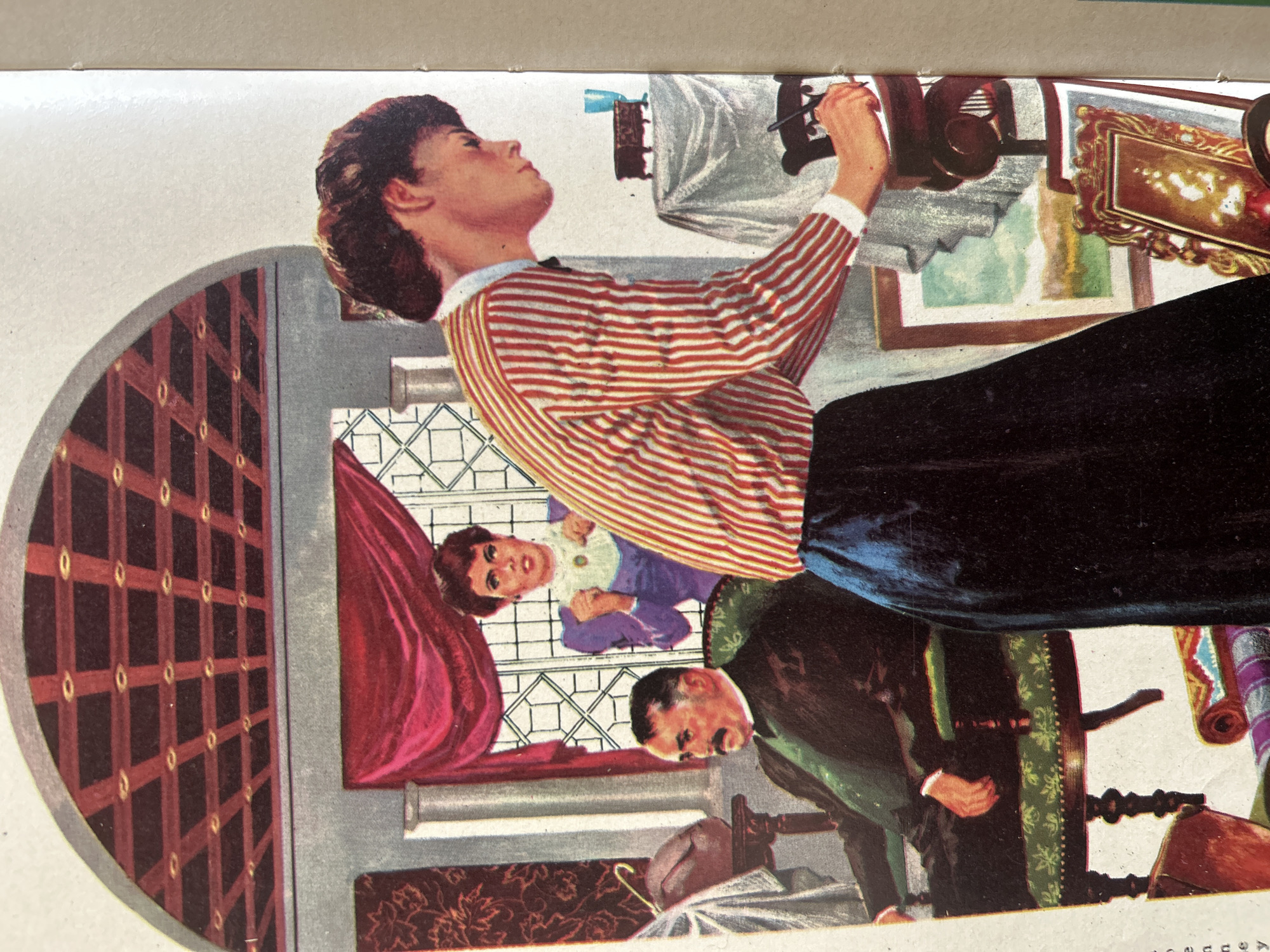 The image depicts an indoor scene featuring three individuals and various objects, set against an architectural backdrop. In the foreground, a woman in a red and white striped long-sleeved shirt and a dark blue skirt is seen from the side, writing or drawing on a piece of paper. Her gaze is directed downwards, and her left hand holds a pen. To the left, a man with a mustache, wearing a dark suit and a green vest, is seated in an ornate chair with a patterned cushion, looking to his left. Behind him, a woman in a purple dress with a white ruffled collar and a green pendant stands by a window, her hands clasped in front of her. The room features a dark, patterned ceiling, draped red curtains, a window with a geometric pattern, and various decorative items including a rolled-up carpet, framed artwork, a wooden box on a draped table, and a small blue glass. The overall style suggests an illustration from a book or magazine. There is no indication of the scene being located in Santa Ana, Venezuela.