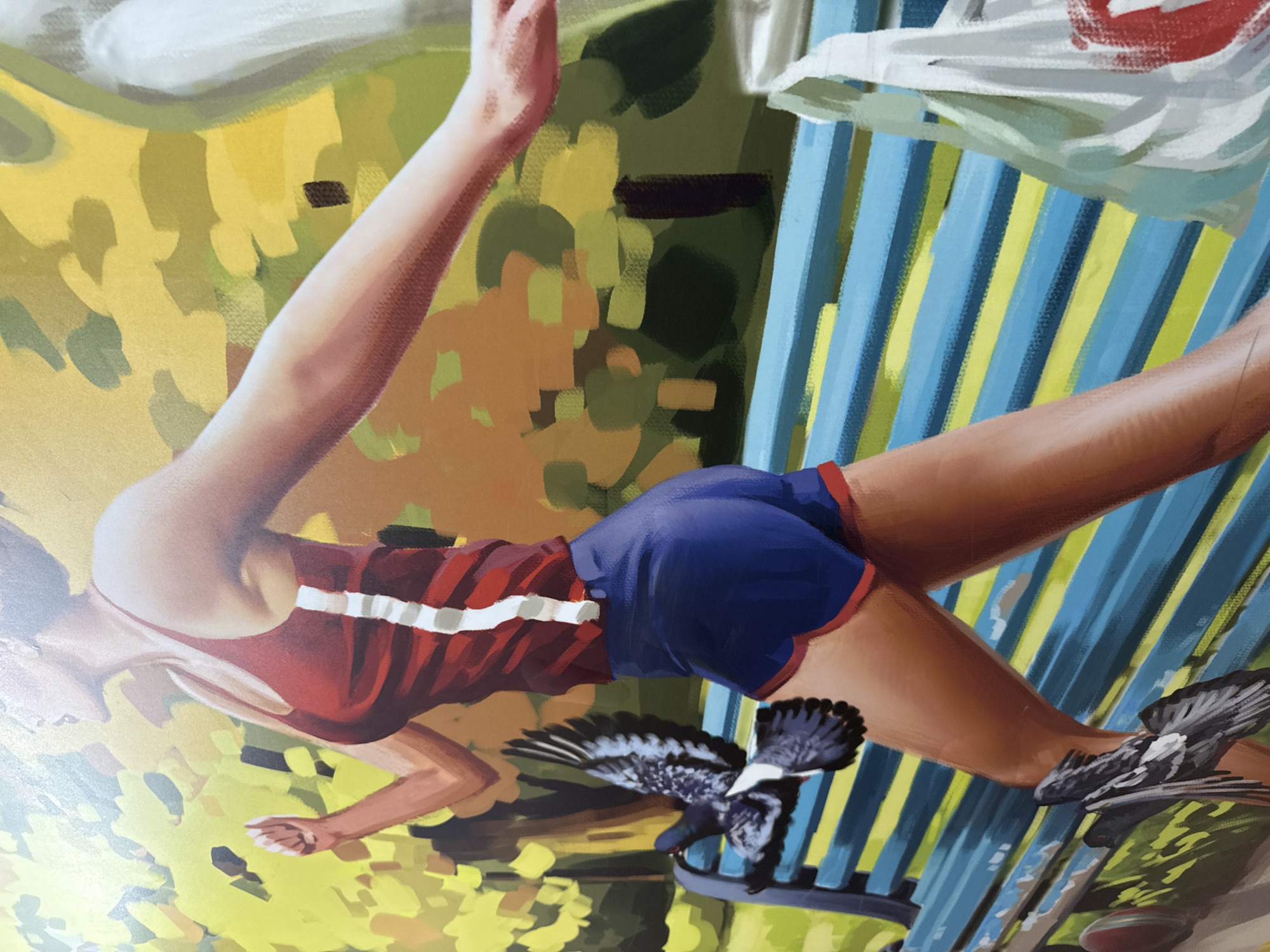 This is a close-up, medium shot painting of a woman running in a park. She is wearing a red tank top with white trim and blue shorts with red trim. Her hair is pulled back, and her face is partially obscured, but her mouth is open as if she is exhaling. She is running past a blue and yellow striped bench. Two pigeons are flying near the bench; one is to the left of the woman, and another is on the ground in front of her. The background depicts green and yellow foliage, suggesting it is either spring or summer in a park. There is a white plastic bag to the right of the woman. The style of the painting is impressionistic, with visible brushstrokes and bold colors. The location is not explicitly indicated to be Moscow, Russia.