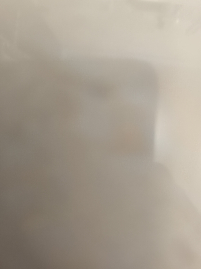 The image is a blurry, out-of-focus shot of a plain, off-white wall. The coordinates provided are located in the city of Tulungagung, Indonesia, but there are no details about the location in the image. It is impossible to identify any objects, subjects, actions, interactions, or any other environmental details in the image.