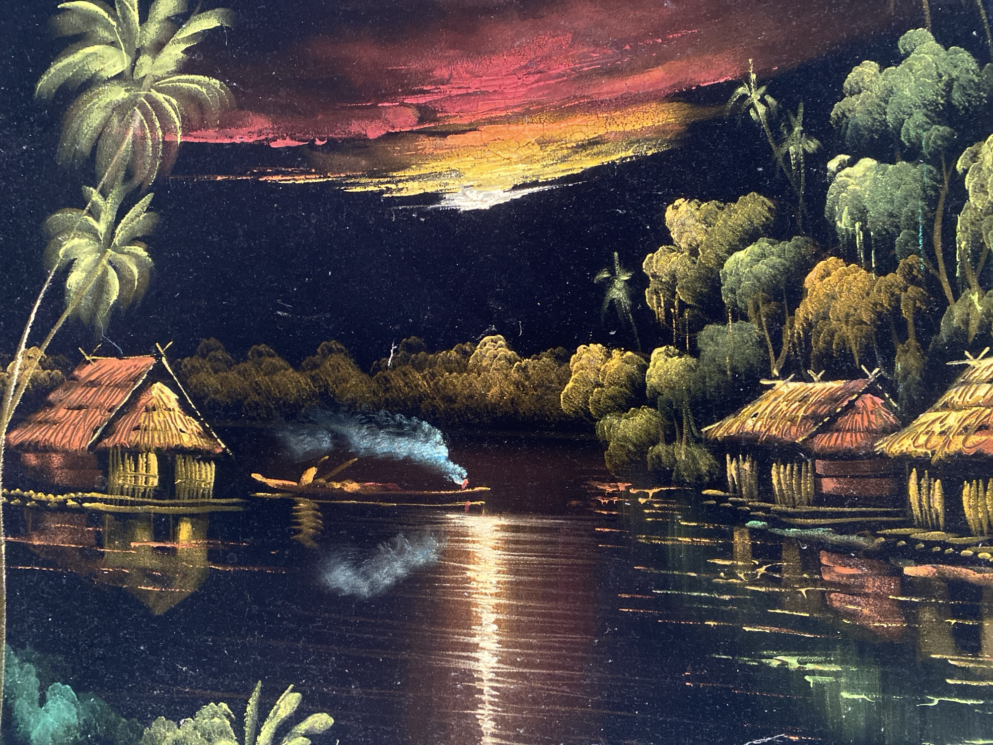 The image depicts a tropical waterfront scene, possibly in Tinaquillo, Venezuela, at night or dusk. There are thatched-roof huts elevated on stilts along the water's edge. Palm trees are visible on both sides of the composition. In the center, a boat with figures is present, emitting smoke or light. The sky transitions from dark to sunset colors, with streaks of red, orange, and yellow. The water reflects light, creating a shimmering effect. The scene evokes a sense of tranquility.