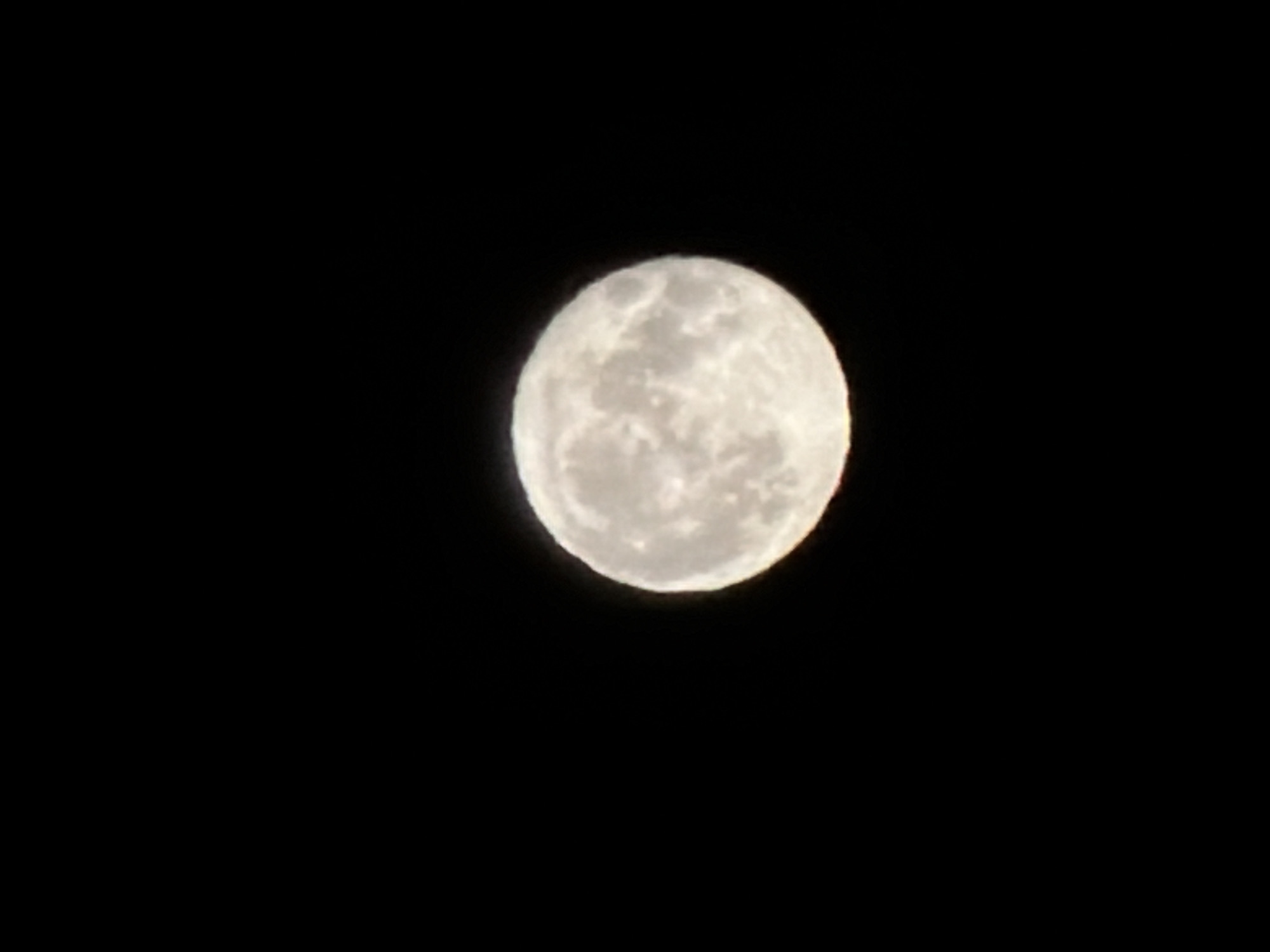 The image shows a full moon in a black sky. There are no other objects or subjects visible. The location of Izhevsk, Russia is not relevant to the image.
