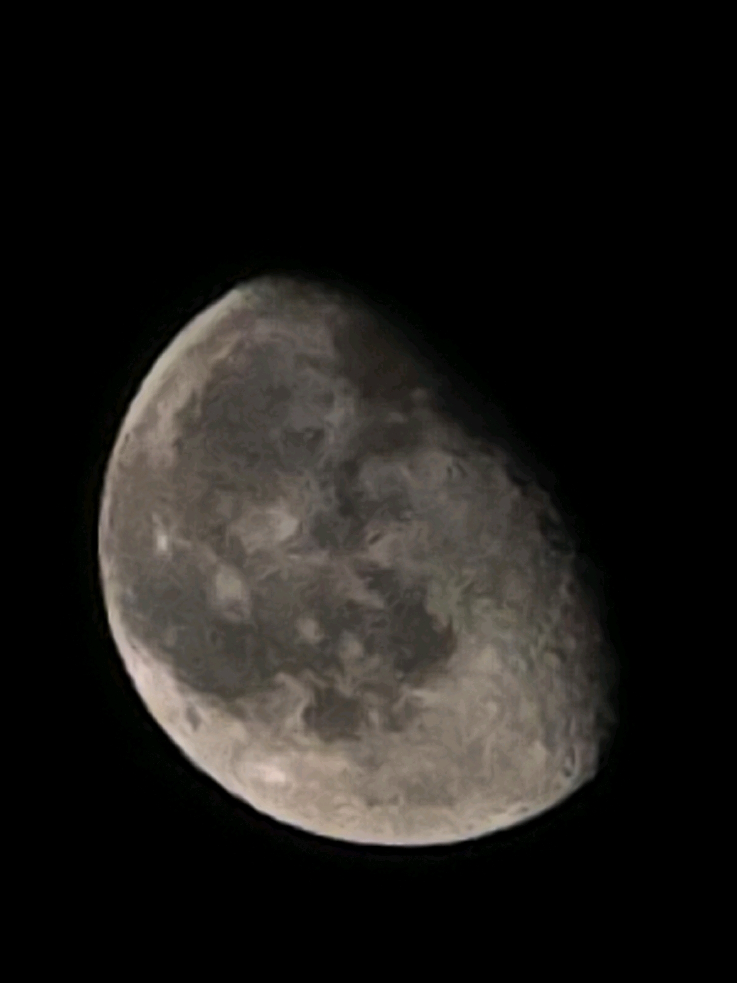 The image displays a close-up view of the moon against a black background. The moon is partially illuminated, showing a crescent shape and revealing surface details such as craters and maria. The lighting suggests a phase where more than half of the moon is visible, but it is not fully illuminated. The scene is devoid of any urban or natural terrestrial features, and there is no indication of the city of Yambol, Bulgaria. The image is purely astronomical in nature.