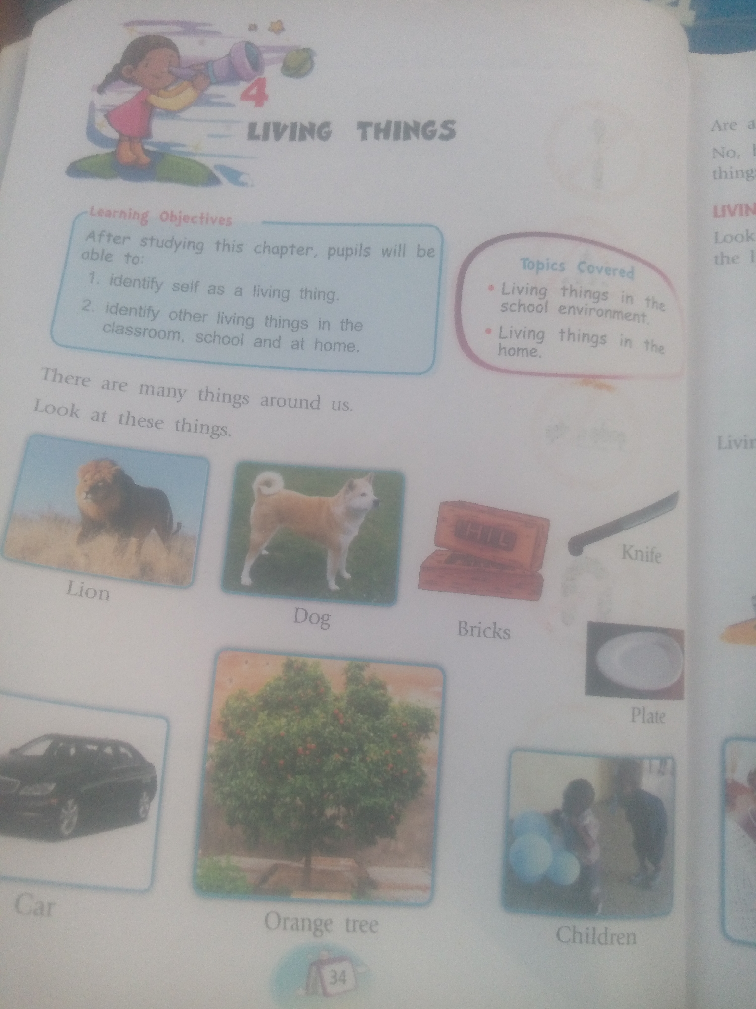 The image shows a page from a children's book or educational material, likely related to science or nature. The top of the page features an illustration of a child looking through a telescope and the chapter title "LIVING THINGS". Below this, there are learning objectives and a list of topics covered.
The majority of the page is dedicated to showcasing various images and their corresponding labels, illustrating different types of living and non-living things. The images include:
* A lion
* A dog
* Bricks
* A knife
* A plate
* A car
* An orange tree
* A group of children holding balloons
The context suggests this is an educational resource for young learners, with the intent of helping them identify and understand the differences between living and non-living things. There are no indications of a specific city or location.