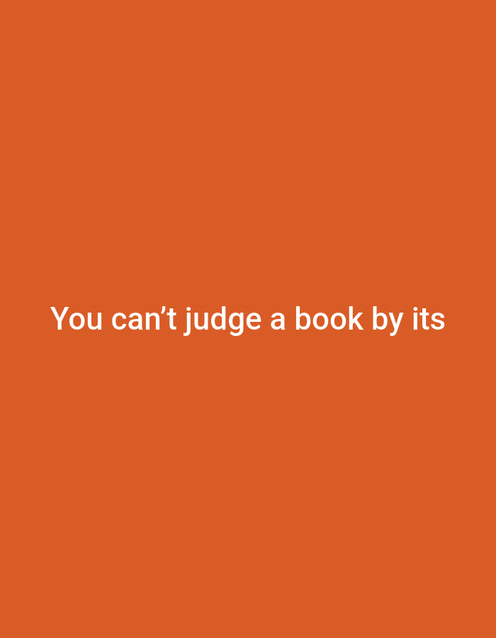 The image is a plain orange background with white text centered on it. The text reads: "You can't judge a book by its". There are no people, objects, or other contextual elements present in the image. The location in the city of Sluck, Belarus is not discernible from the provided image.