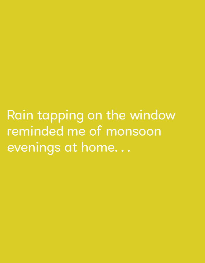 The image is a solid yellow background with the following text in white: "Rain tapping on the window reminded me of monsoon evenings at home...". The coordinates provided, latitude: 17.808, longitude: 83.197, correspond to a location in Visakhapatnam, India. There are no people, subjects, objects, actions, interactions, or any other environmental details in this image.