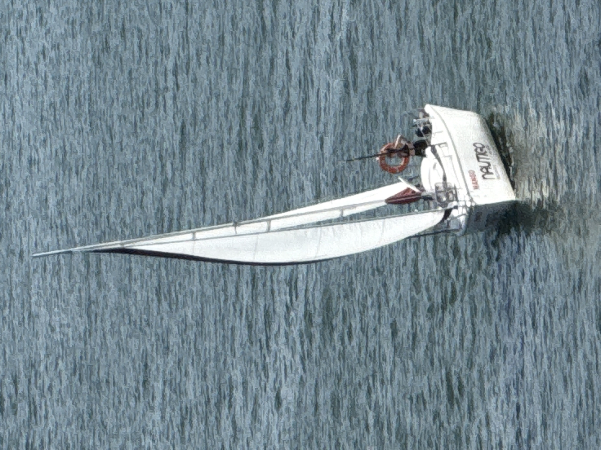 The image shows a white sailboat in a body of water. The sailboat appears to be capsized or partially submerged, with its hull visible above the water. A person can be seen on board the sailboat, holding onto a life preserver. The water has a textured, rippling appearance, suggesting it might be choppy. The scene is likely outdoors, given the presence of the sailboat and the water.
Visible text on the sail reads "NAUTIGO" and "NANGÓ".
The image's style is painterly, with a visible texture that resembles brushstrokes. The lighting suggests daytime, but no specific time can be determined. The overall impression is one of a dramatic event at sea, with the capsized sailboat and the person struggling for survival. The location context provided is Mikołajki, Poland, which is known for its lakes, making it a plausible setting for a sailing incident.