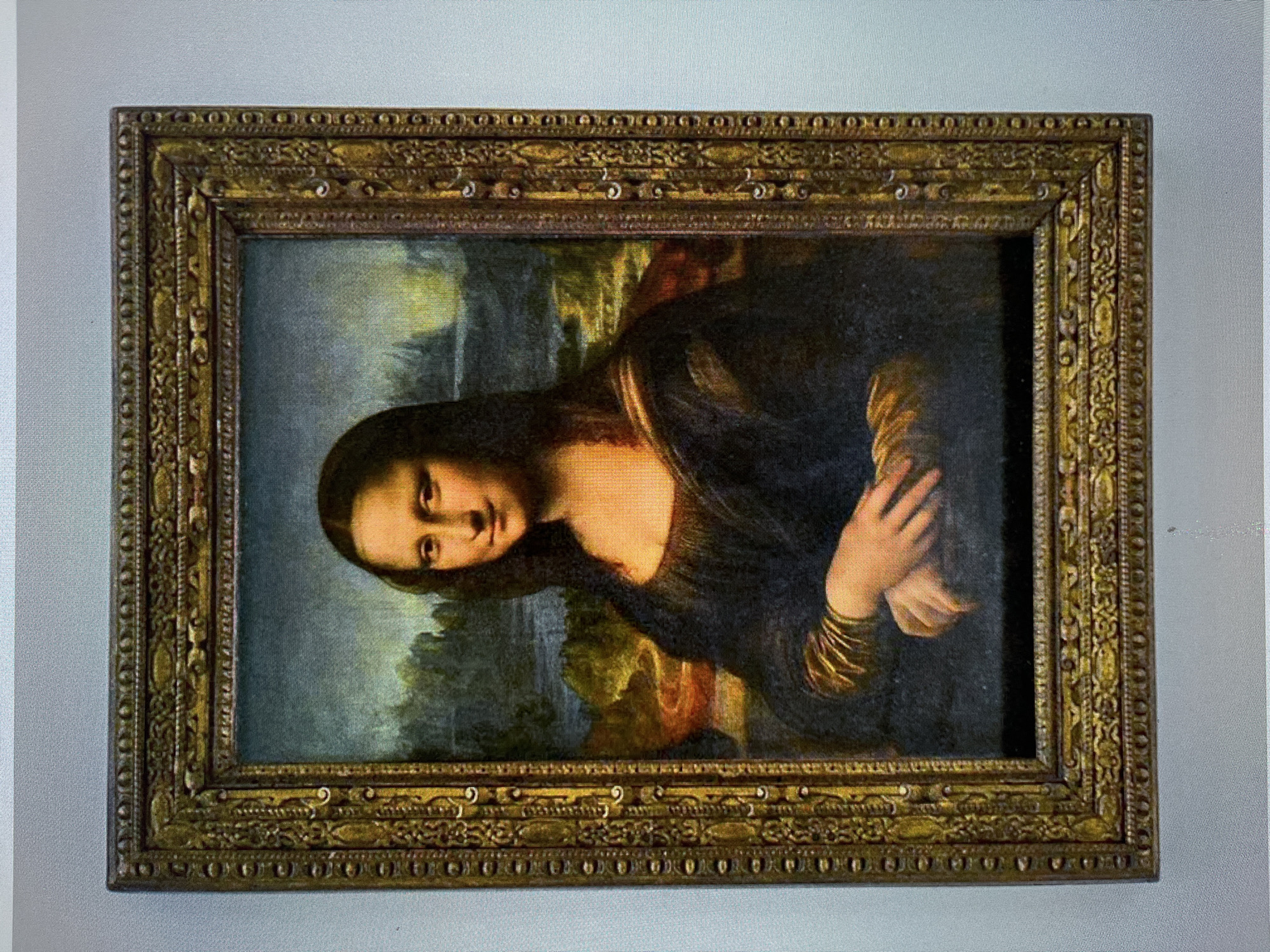 The image shows a framed reproduction of Leonardo da Vinci's Mona Lisa. The frame is ornate and gold-colored. There is no evidence to indicate that this image was taken in the city of Ореховка, Russia.