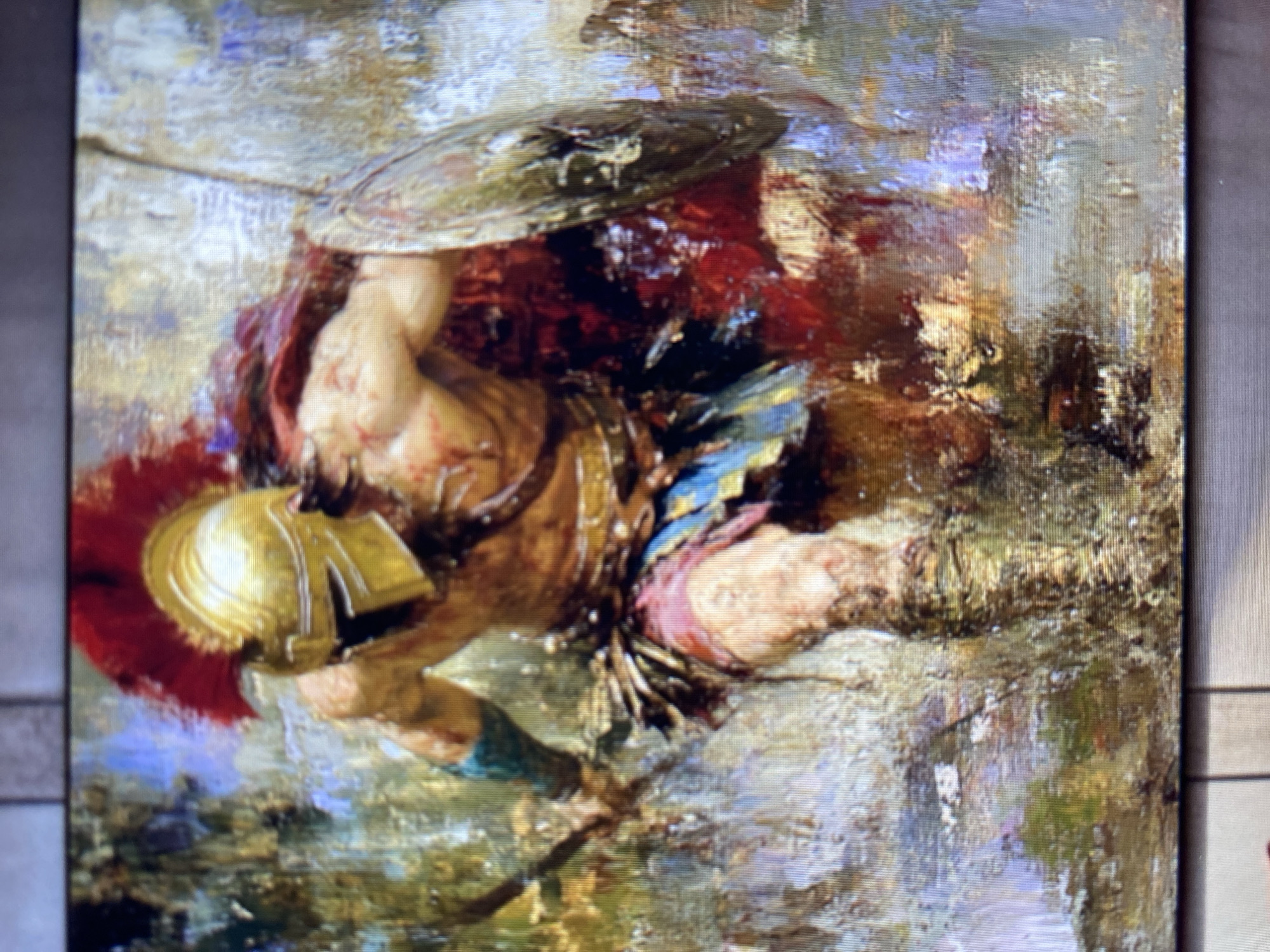 The image is a painting depicting a Spartan warrior in battle. The warrior is wearing a golden helmet with a red plume, a red cape, and a blue and gold skirt. He is holding a shield in his left hand and a spear in his right. His body is muscular and appears to be injured, with blood visible on his chest and arm. The background is abstract and impressionistic, with a mix of colors and brushstrokes suggesting a chaotic battlefield. The painting is rendered in a realistic style, with a focus on the dynamic pose and dramatic lighting.