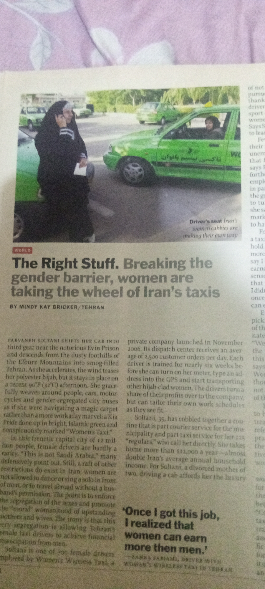 The image shows a newspaper article with a headline that reads "The Right Stuff. Breaking the gender barrier, women are taking the wheel of Iran's taxis." The article is accompanied by a photograph featuring two women. One woman, wearing a black hijab and abaya, is standing outside a green taxi and appears to be speaking on a mobile phone. The second woman, also wearing a hijab, is visible inside the driver's seat of the same taxi. The taxi has text in Persian script on its side. The background suggests an urban or semi-urban environment with other vehicles, possibly more taxis, and some foliage. The article is by Mindy Kay Bricker and is datelined Tehran. The location of Jalingo, Nigeria is not depicted or mentioned in the image.