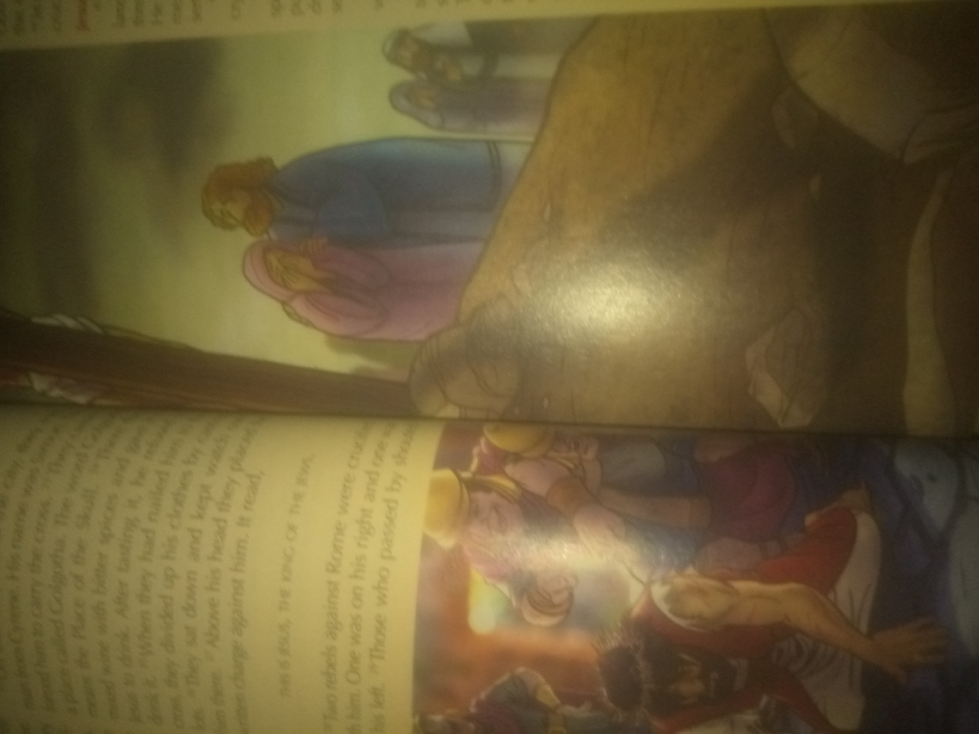 The image depicts two illustrated scenes from a book. The upper scene shows a figure in a blue robe bending over another figure draped in pink. The faces are not clearly defined. The lower scene shows multiple figures, some appearing to be in distress or conflict. One figure in red and white is lying down, with another figure in yellow and pink bending over them. The overall aesthetic suggests a historical or religious narrative.
There is no information or visual evidence within the image that can be used to identify the location as the city of Jauro Yinu, Nigeria.