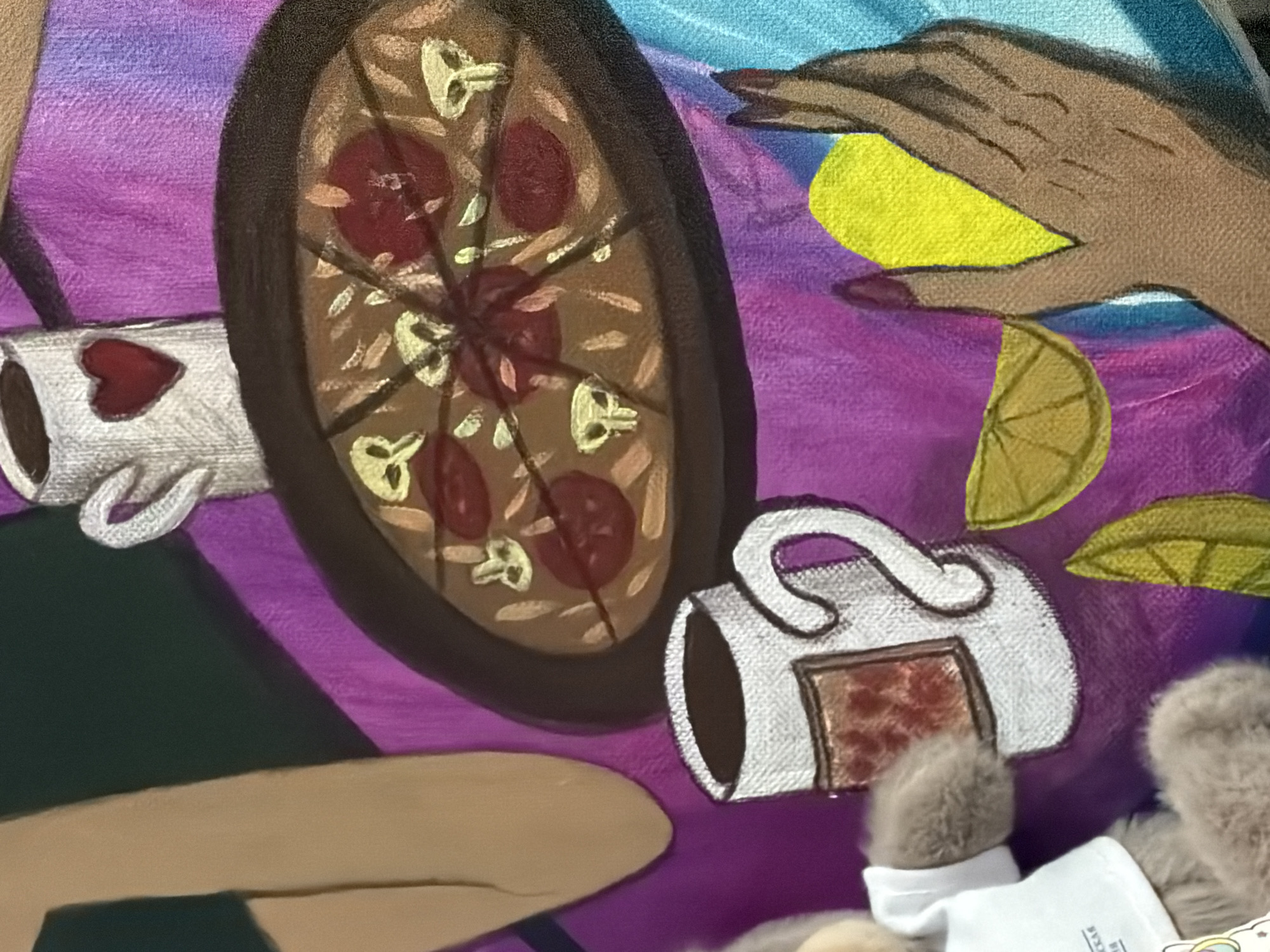 The image is a close-up of a painting, depicting a still life scene. In the foreground, a teddy bear wearing a white shirt is partially visible on the left. To the right of the bear, a white mug with a brown interior and a square label with a red pattern is depicted. Further to the right, a human hand with dark nail polish is holding a yellow lemon slice. Several other lemon slices and a whole lemon are also visible. A pizza is in the center, on a dark plate. Above the pizza, another white mug with a red heart is visible. The background is a textured purple and blue fabric. There is no indication of the city of Moscow, Russia, or any specific urban environment.