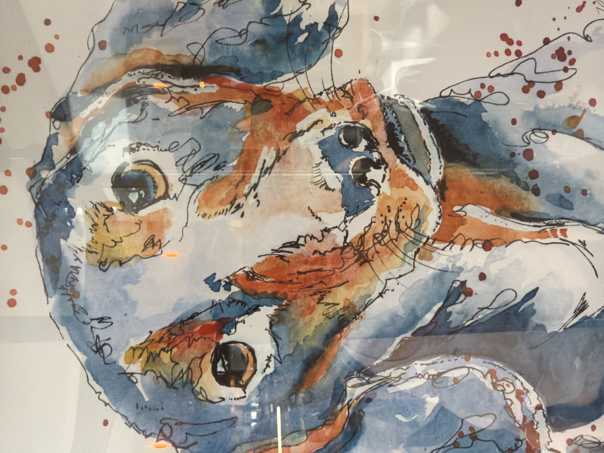 The image is a close-up watercolor painting of three dogs, seemingly captured in a dynamic pose or interaction. Predominantly blue and orange hues define the color palette. The painting is enclosed in a glass frame. Brown spots are scattered around the artwork. The location is unknown; nothing about the image suggests a location in London, United Kingdom.