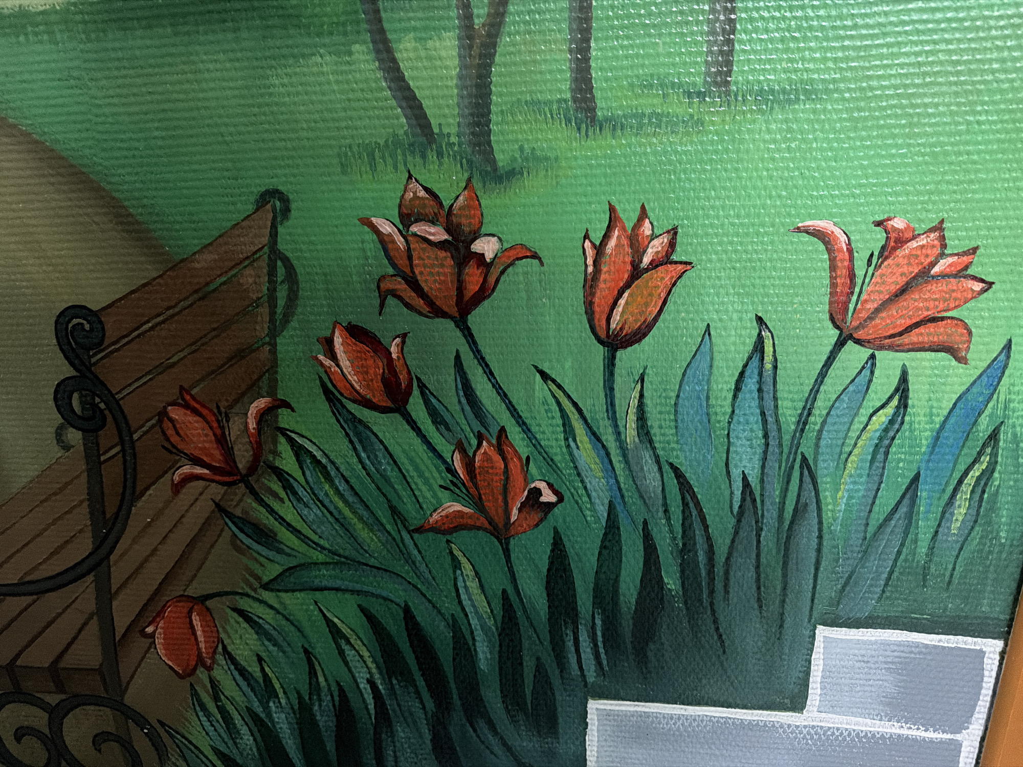 This is a close-up image of a painting depicting a tranquil garden or park scene, likely set in Chaikovsky, Russia, based on the provided context. The foreground is dominated by a cluster of stylized red-orange flowers, resembling tulips, each with distinct petals and dark outlines. These flowers are interspersed with broad, dark green and blue-green leaves, also with noticeable outlines.
To the left, a section of a park bench is visible, featuring brown wooden slats and a dark, ornate metal armrest with scrollwork. The background consists of an expanse of bright green grass, rendered with horizontal brushstrokes that highlight the canvas texture. In the upper background, several dark, slender tree trunks with faint foliage are silhouetted against the green.
In the bottom right corner, a light grey or white architectural element, possibly a low wall or planter box, is partially visible. The painting exhibits a clear, illustrative style with defined outlines and visible brushwork on a textured surface, possibly canvas. The scene conveys a peaceful, daytime outdoor atmosphere. There is no specific activity taking place, and no text is visible within the image.