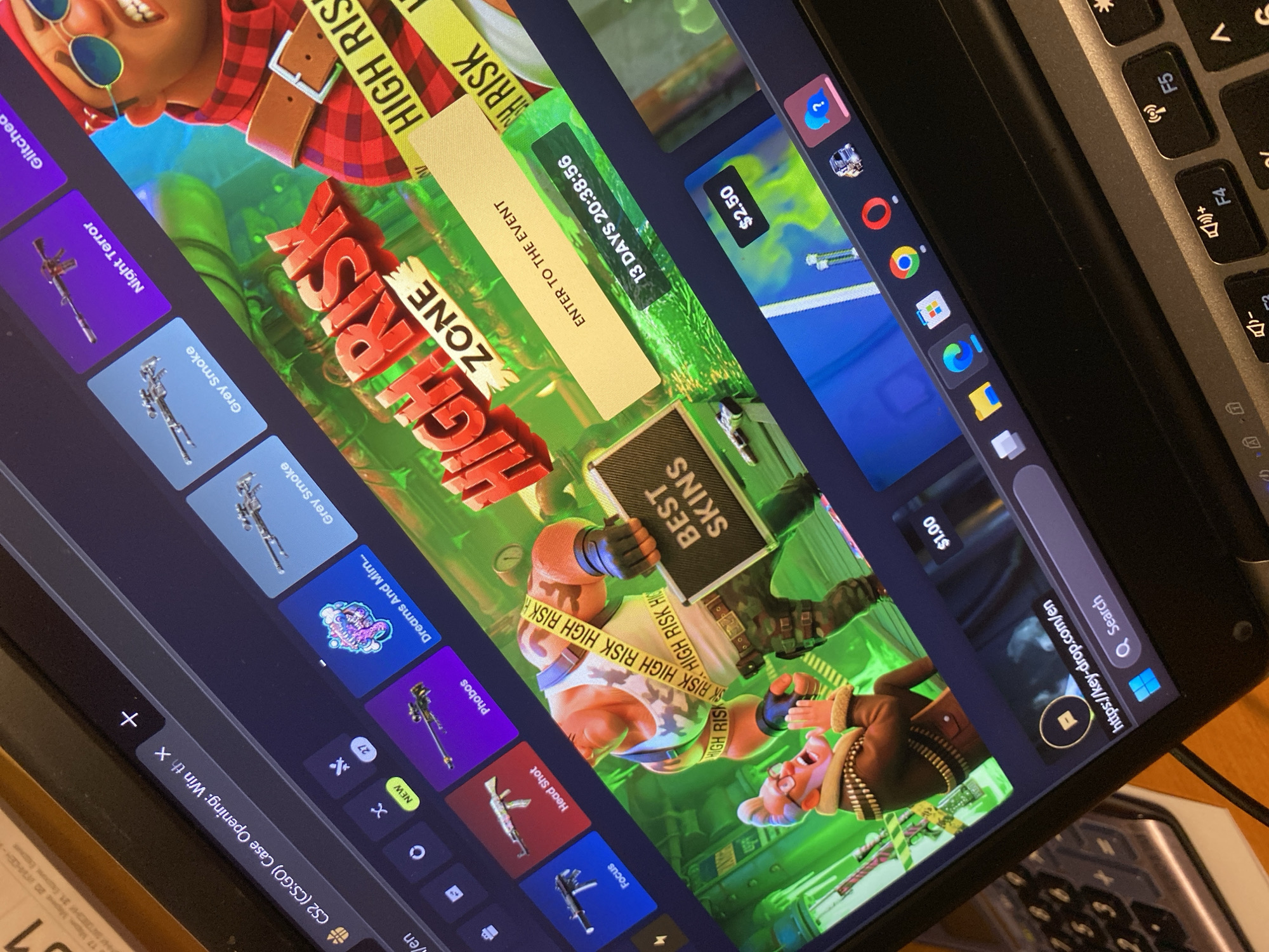 The image shows a laptop screen displaying a website for "CS2 (CS:GO) Case Opening." The website features colorful graphics and various in-game item icons, along with promotional text such as "HIGH RISK ZONE" and "ENTER TO THE EVENT." A countdown timer indicates "13 DAYS 20:38:56." The browser's address bar shows "https://key-drop.com/en" and a search bar. The laptop is placed on a wooden surface, and part of a keyboard is visible. The scene is an indoor setting, likely a room. There is no discernible connection to Smolyan, Bulgaria.