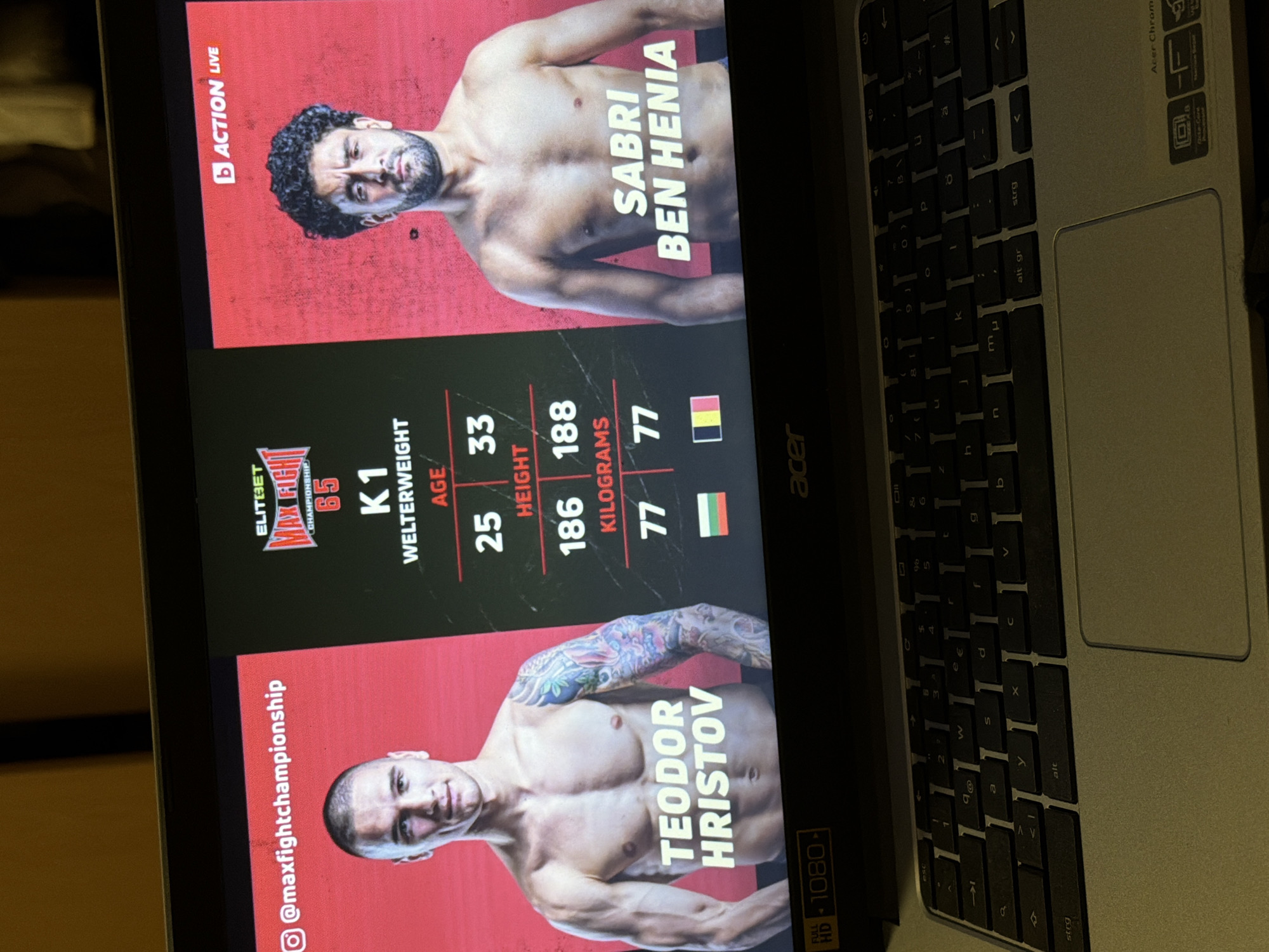 The image shows a laptop screen displaying a fight card for a match between Teodor Hristov and Sabri Ben Henia, under the "Elitebet Max Fight Championship". Hristov, a 25-year-old Bulgarian fighter, is on the bottom. Ben Henia, a 33-year-old Belgian fighter, is on the top. The event is marked as "Action Live". The Instagram handle "@maxfightchampionship" is visible. The laptop's keyboard is visible on the right. The flag of Bulgaria is present. Sofia is the capital of Bulgaria.
