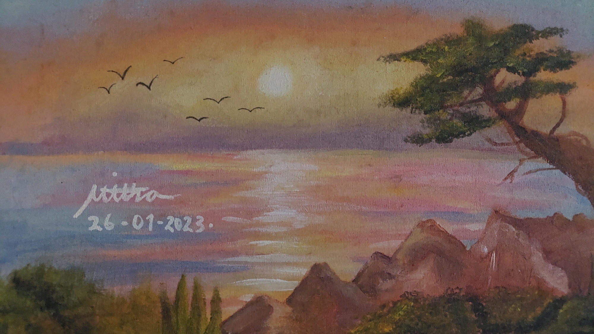 The painting depicts a serene sunset over the ocean. The sky is painted in warm hues of orange, pink, and purple, with the sun appearing as a bright white orb. Several birds are silhouetted against the sky, flying in formation. The ocean reflects the colors of the sunset, creating a shimmering effect. In the foreground, there are rocky cliffs and lush green vegetation. A lone, gnarled tree with dark green foliage stands on the right side of the painting, its branches reaching towards the sky. In the lower left quadrant, a signature and date are inscribed in white: "mittra" and "26-01-2023". The painting is done in an impressionistic style, with visible brushstrokes contributing to the overall texture and atmosphere. The scene evokes a sense of peace and natural beauty. There is no indication of the city of Bojong Gede, Indonesia within the image itself.