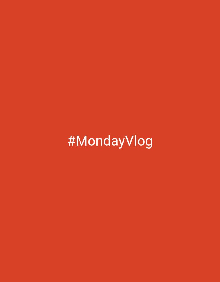 The image is a plain orange background with white text in the center that reads "#MondayVlog". There are no people, objects, or environmental details present to suggest a specific location in Chaikovsky, Russia, or anywhere else.