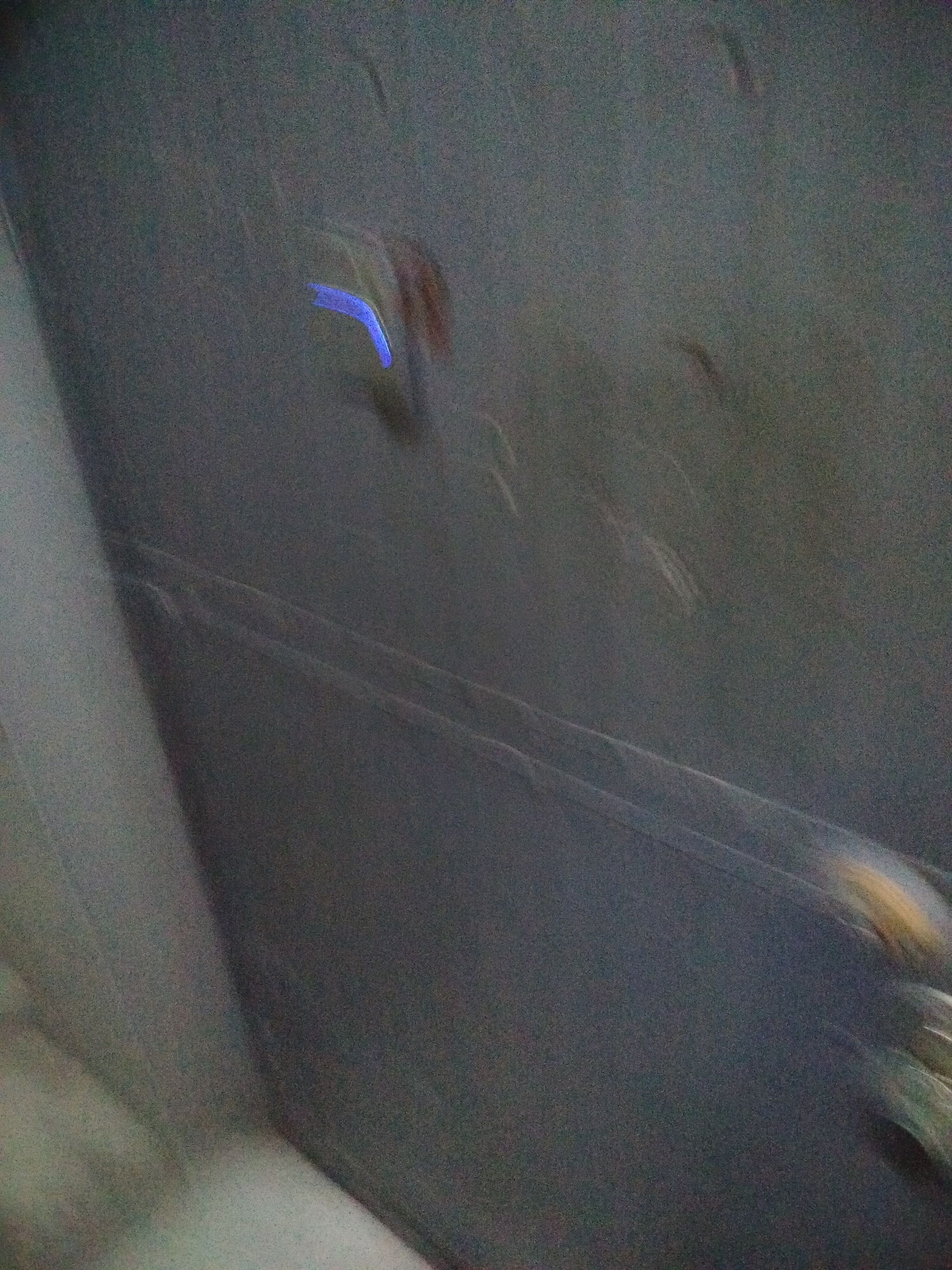 The image shows a blurred indoor scene with unclear details. A blue light source is visible in the upper center area. Lines or edges suggest structural elements in the composition, possibly of a ceiling or wall. The location in Yerevan, Armenia, is unknown from the image itself.