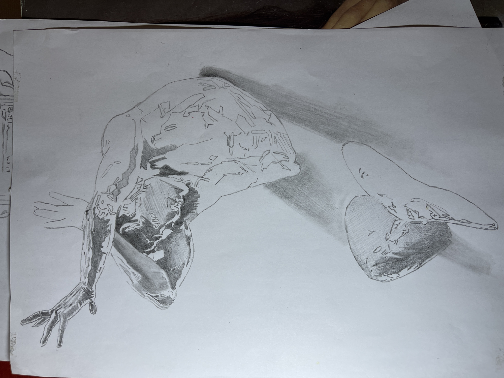 A pencil sketch on paper depicts a figure in an abstract pose. The figure's arm is extended towards the lower-left corner, with fingers splayed. The torso is bent, and the head is obscured by shading. The body has numerous lines and shaded areas suggesting contours or details. A shadow extends from the figure towards the right side of the paper. The drawing fills most of the page. The image does not depict any specific location in Jos, Nigeria, or any other identifiable place.