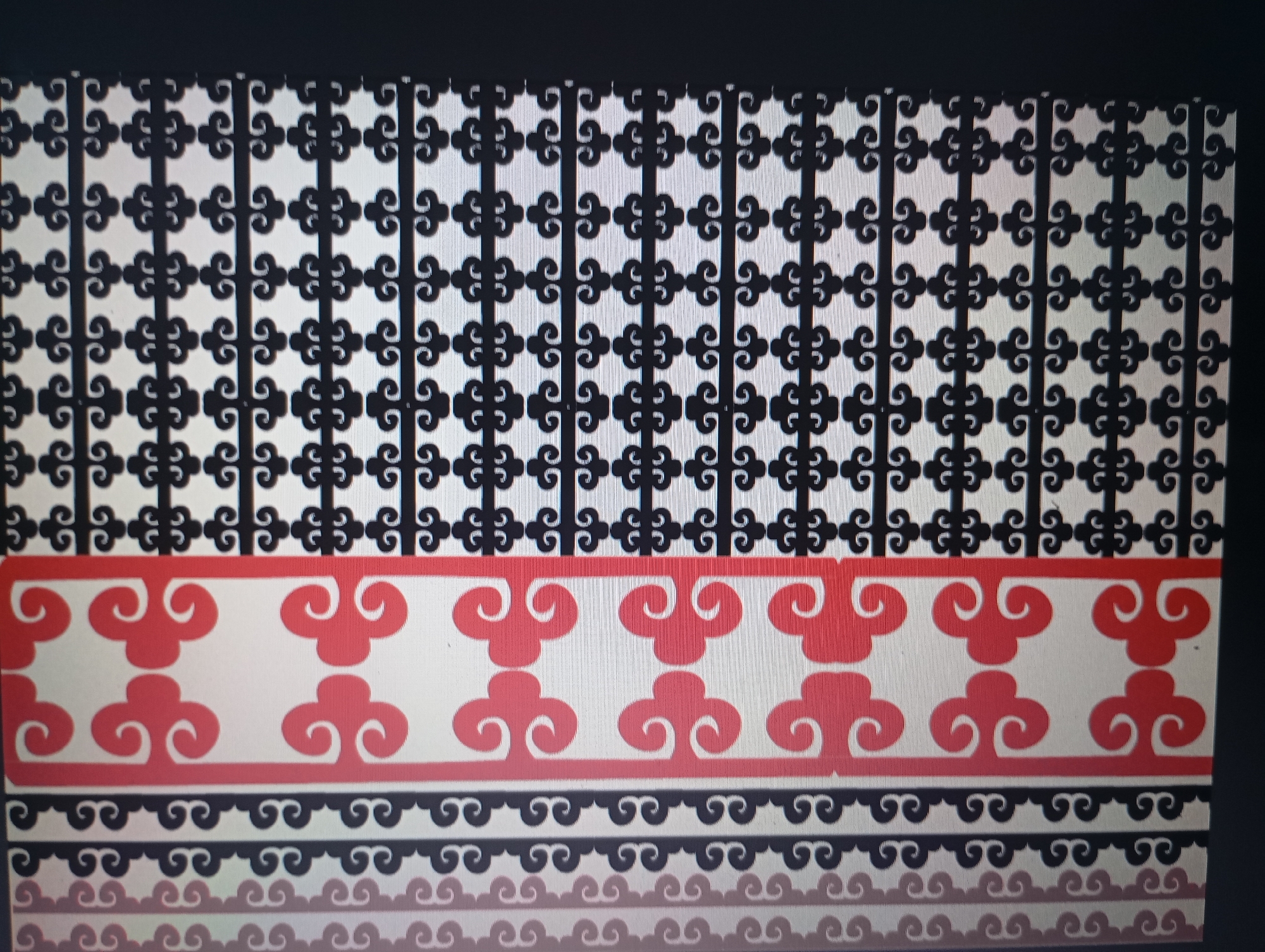 The image shows a rectangular pattern or design. The top portion features a repeating black motif of stylized swirls or "S" shapes arranged in a grid-like fashion against a white background. Below this, a band of red stylized cloud shapes repeats across a white background, framed by red lines above and below. At the bottom, there are two repeating rows of black swirl shapes on a white background, with a fainter, blurred row underneath. The location and specific object depicted are unknown.