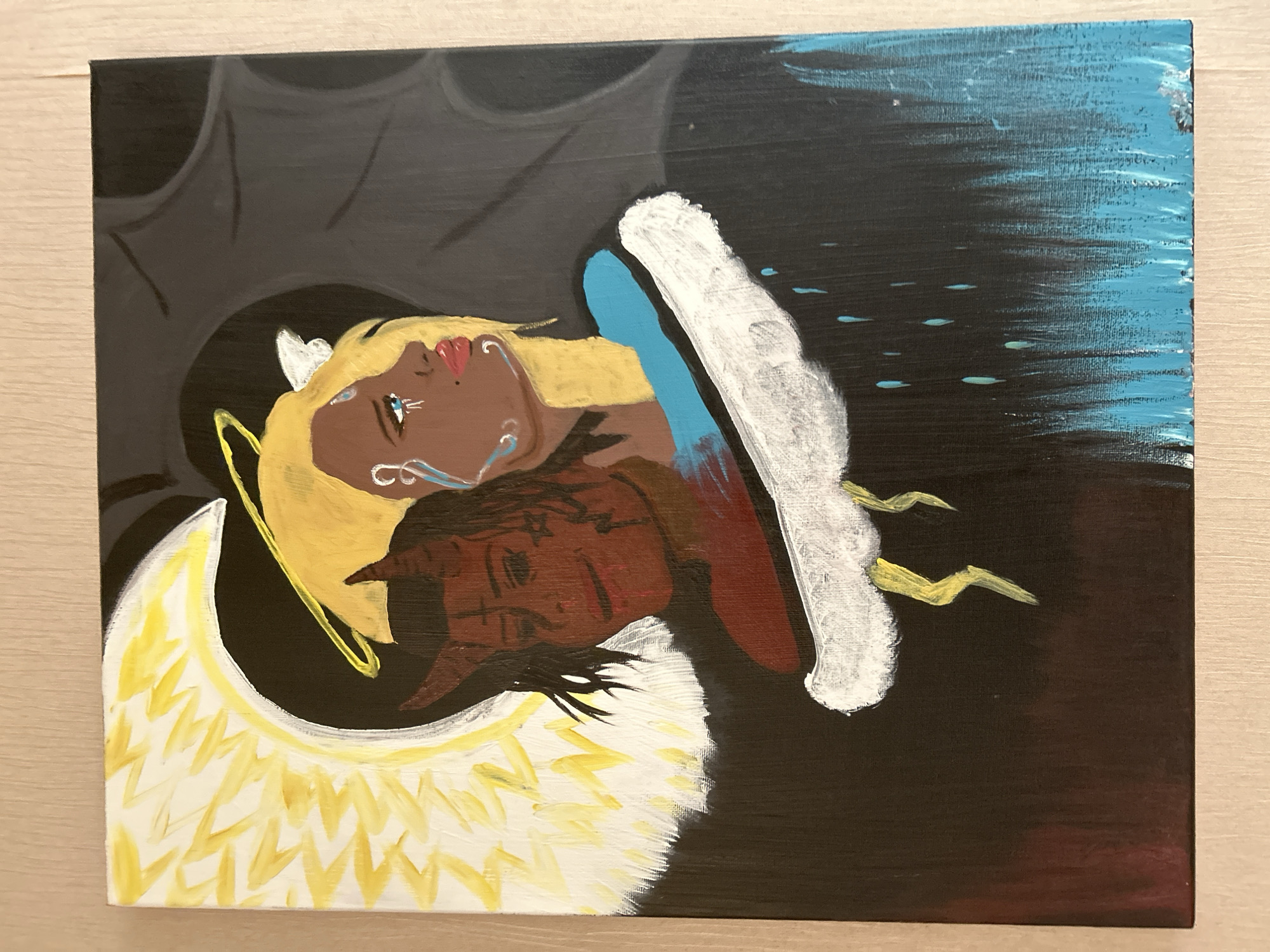 The image displays a vertical acrylic painting on canvas, presenting a symbolic representation of duality. The central focus features two distinct, conjoined faces, appearing to share a single body.
On the left, an angelic figure is depicted with dark brown skin, blonde hair, and a bright yellow halo encircling its head. A prominent white and yellow feathered wing formation arcs from the left edge, framing this figure. The angelic face exhibits a contemplative expression, with a single blue tear descending from its visible eye and decorative white markings on its cheek. A small pair of white wings is visible near the halo. A section of a vibrant blue garment covers its shoulder.
On the right, a devilish figure is shown with reddish-brown skin, dark hair, and two distinct red horns. This face displays a more melancholic or grim expression, with its visible eye partially obscured and faint dark markings on its skin. The background behind this figure is a dark grey, featuring subtle, abstract, wavy patterns resembling shadows or organic forms.
Beneath the conjoined figures, a horizontal, textured white cloud-like structure spans across the lower central portion of the canvas. From the left side of this cloud, two jagged yellow lightning bolts extend downwards. From the right side, multiple light blue teardrop shapes, resembling raindrops, descend against a dark background. The bottom right section of the painting transitions into a textured field of bright blue. The scene is an artistic, symbolic representation and does not depict a real-world location in the city of Unknown, Unknown.