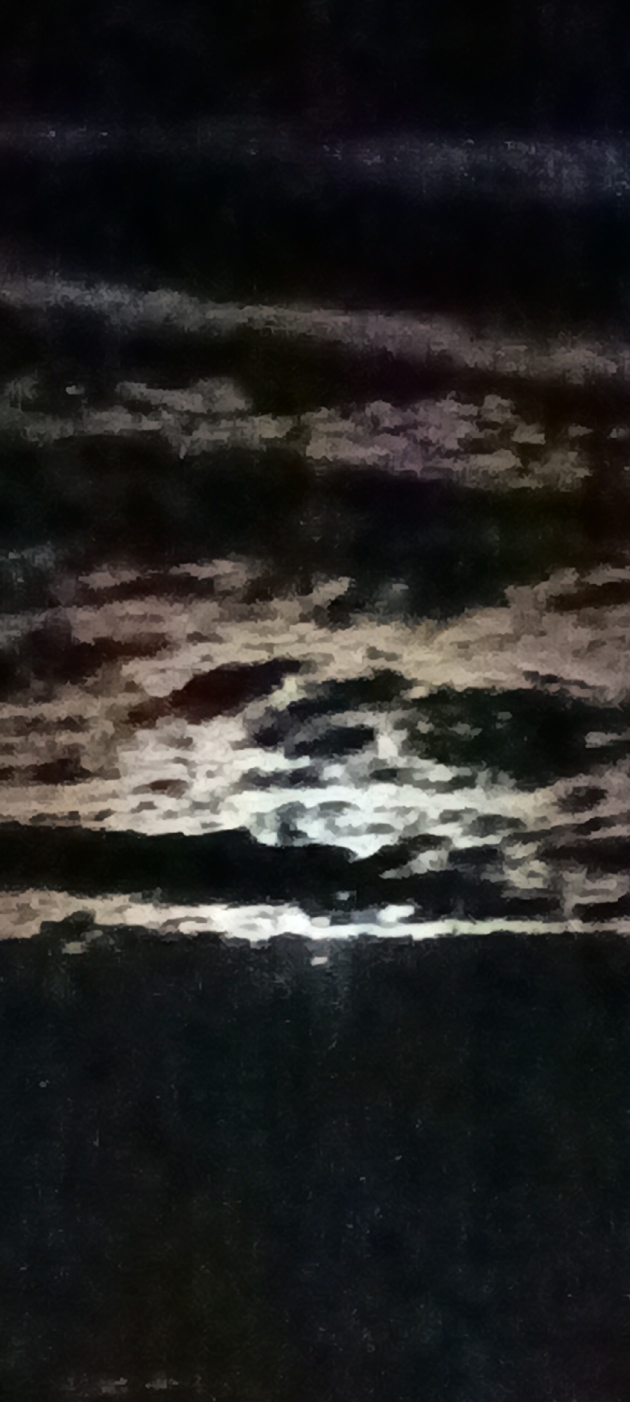 The image is a digitally altered photograph of a night sky. The sky is dark, with streaks of light suggesting clouds illuminated by a moon or other light source. The overall effect is painterly, with a rough texture and blurred edges. The bottom portion of the image is solid dark blue-black, with no discernible features. There are no people, objects, or environmental details visible, making it impossible to determine the location within a city or any specific context.