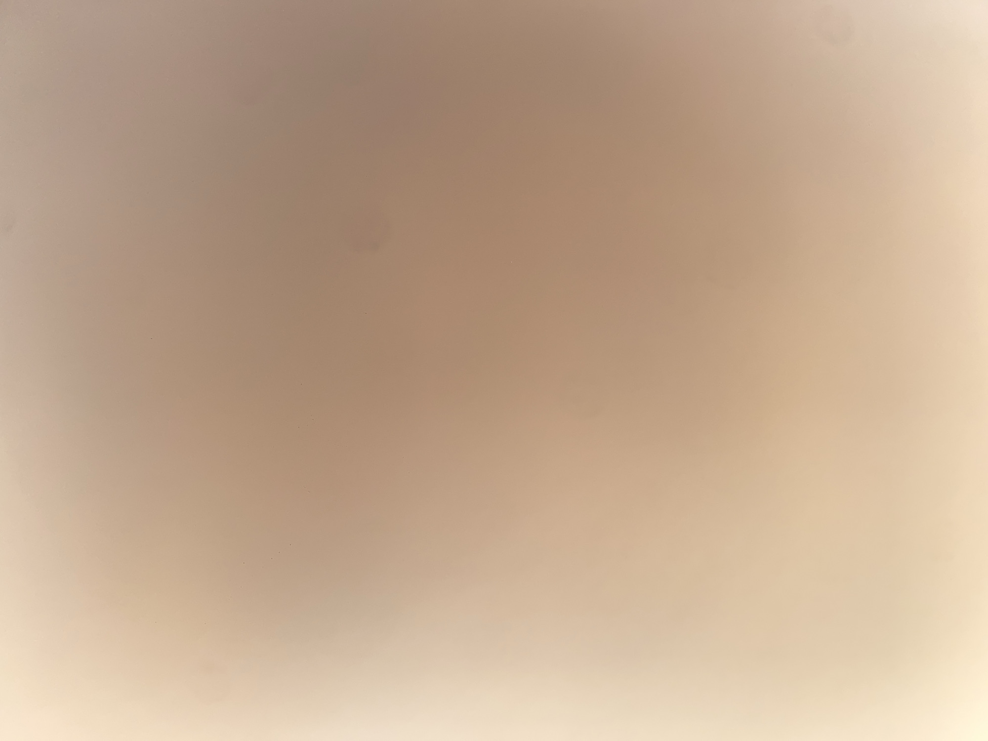 The image is an abstract shot of a smooth, light-colored surface with subtle variations in tone and illumination. The surface appears to be uniformly textured, with no discernible objects or features. The lighting creates a soft gradient, with a brighter area on the lower left and a darker, more uniform tone across the rest of the image. There are no people, animals, or any other living subjects present. The overall impression is one of simplicity and minimalism, with the focus on the texture and light of the surface. There is no indication of a specific location within the city of Ablanitsa, Bulgaria, or any environmental context that would place it there.