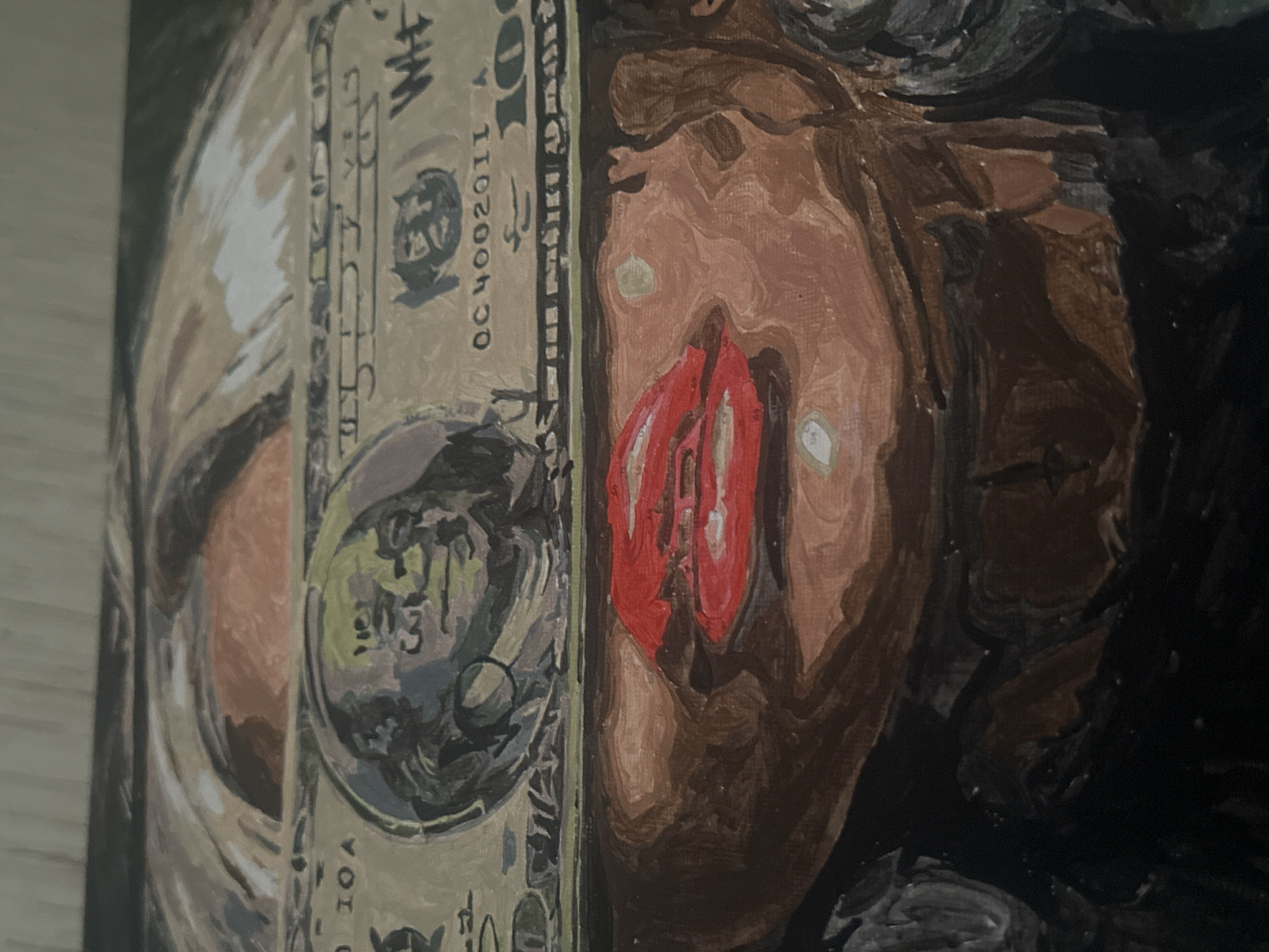 The image is a close-up of an oil painting. The artwork depicts a US one-dollar bill placed next to part of a person's face. The dollar bill is painted in a stylized, slightly distorted manner. The face is predominantly brown with hints of red. The background appears dark. There is no evidence in the image to indicate the location in the city of Высокий, Russia.