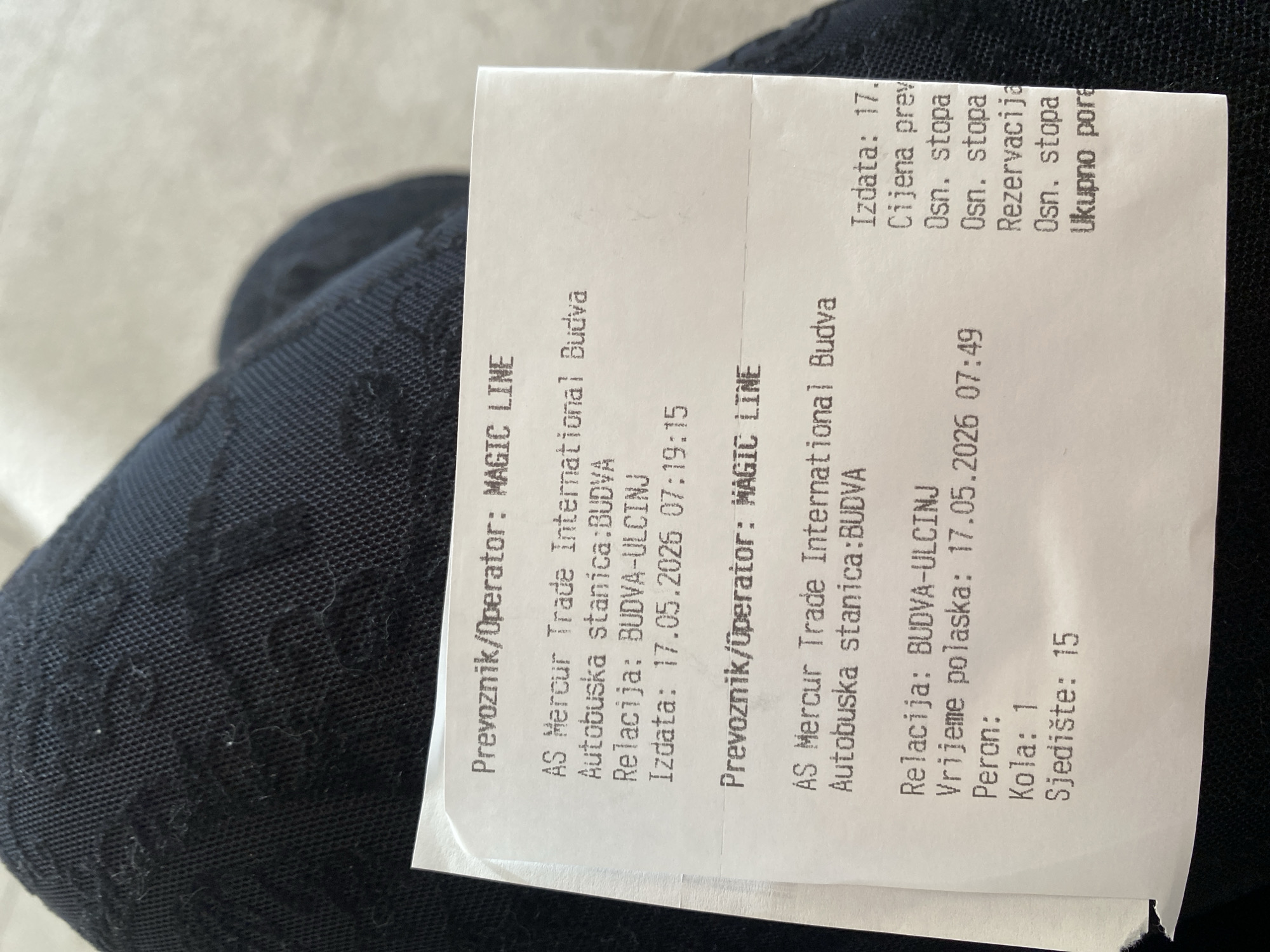 The image shows a bus ticket for a trip from Budva to Ulcinj. The bus operator is MAGIC LINE, and the departure station is Autobuska stanica:BUDVA (Budva Bus Station). The ticket was issued on May 17, 2026, at 07:19:15, with the departure time set for May 17, 2026, at 07:49. The bus number is 1, and the seat number is 15.