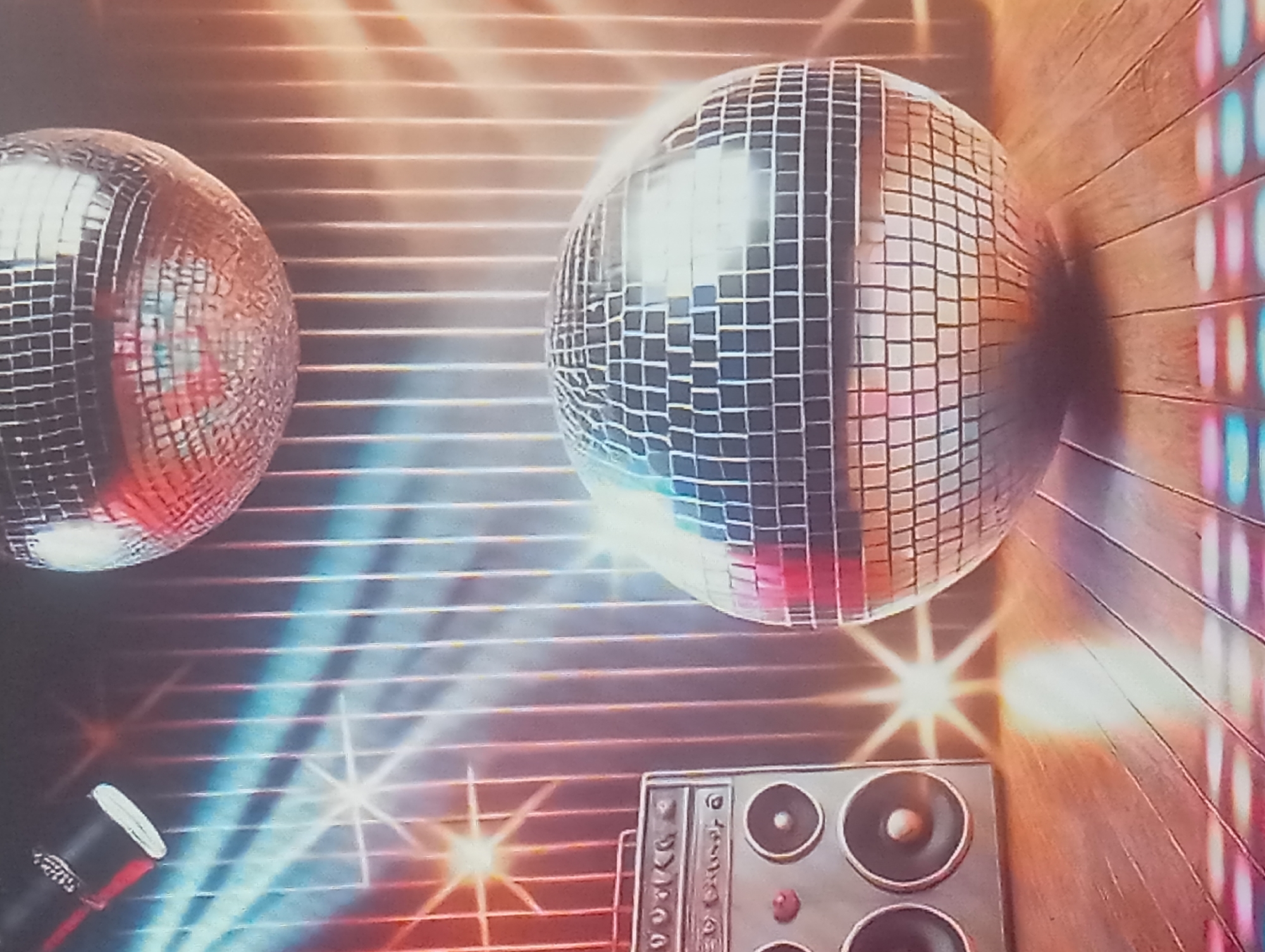 The image features two disco balls, one slightly larger and more centrally located than the other, which is positioned on the left side of the frame. Below the larger disco ball is a boombox. The background consists of horizontal stripes of varying colors, with light flares creating a sense of motion. The overall aesthetic suggests a party or dance setting. There is no evidence to suggest this image was taken in Karaganda, Kazakhstan.