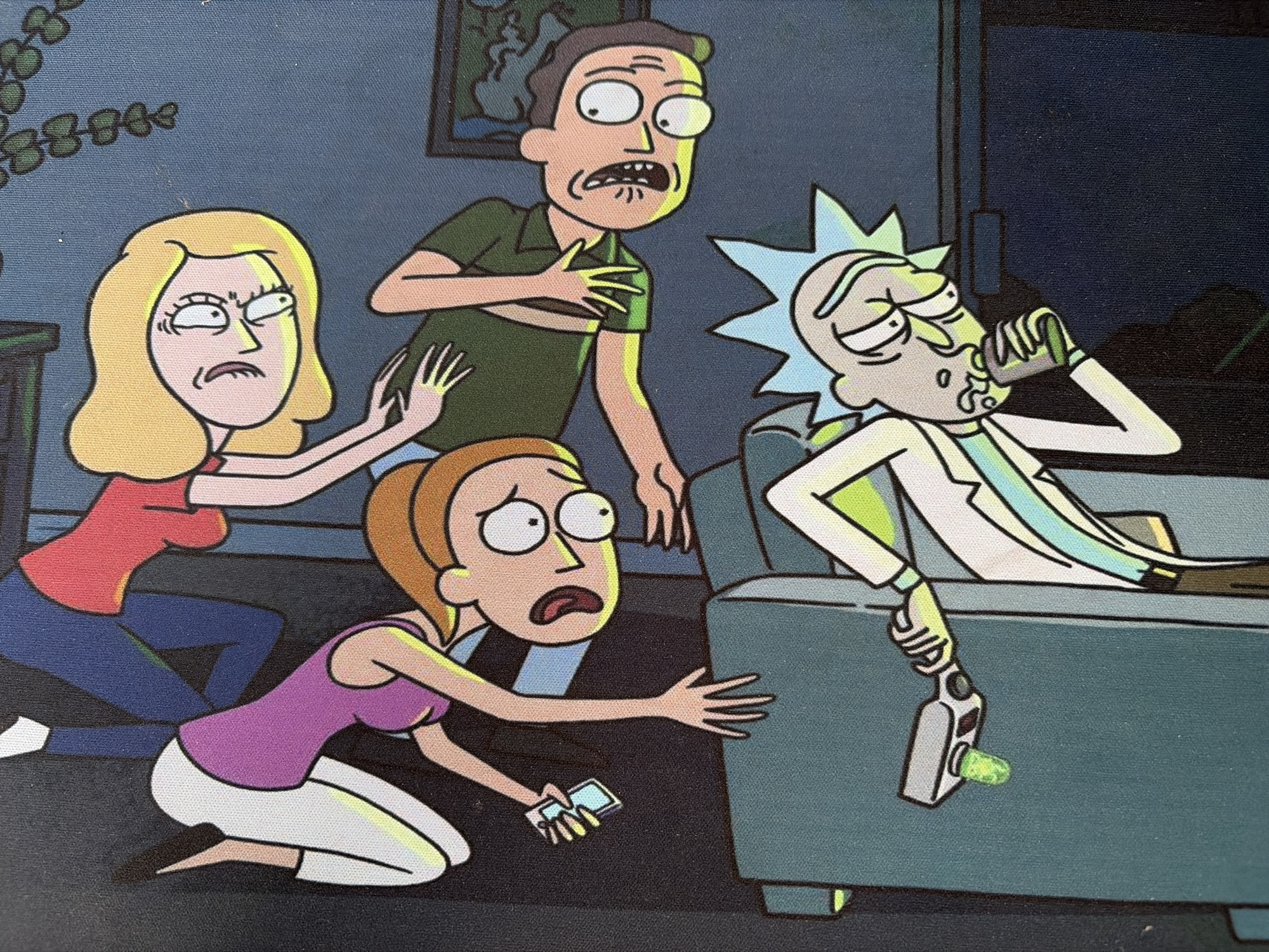 The image is a close-up shot of a colorful illustration featuring characters from the animated show "Rick and Morty". The style is a flat, cartoon aesthetic with bold black outlines and vibrant colors. In the foreground, Rick Sanchez is depicted with his signature wild hair and lab coat, holding a portal gun that is emitting a green substance. He appears to be taking a drink from a flask. Behind him, a group of other characters are arranged in a chaotic and dynamic pose. From left to right, a female character in a purple top and white pants is reaching out, holding a small rectangular object, possibly a phone. To her right, another female character in a red top is positioned higher, with her head tilted back and tongue sticking out. Between them, a male character in a green shirt is lying down, with his arms outstretched. The background is a dark blue, with a hint of a plant and a framed picture on the wall. The overall impression is one of an energetic and somewhat disheveled scene. This image is not located in Mirnoye, Ukraine, as it is a fictional illustration.