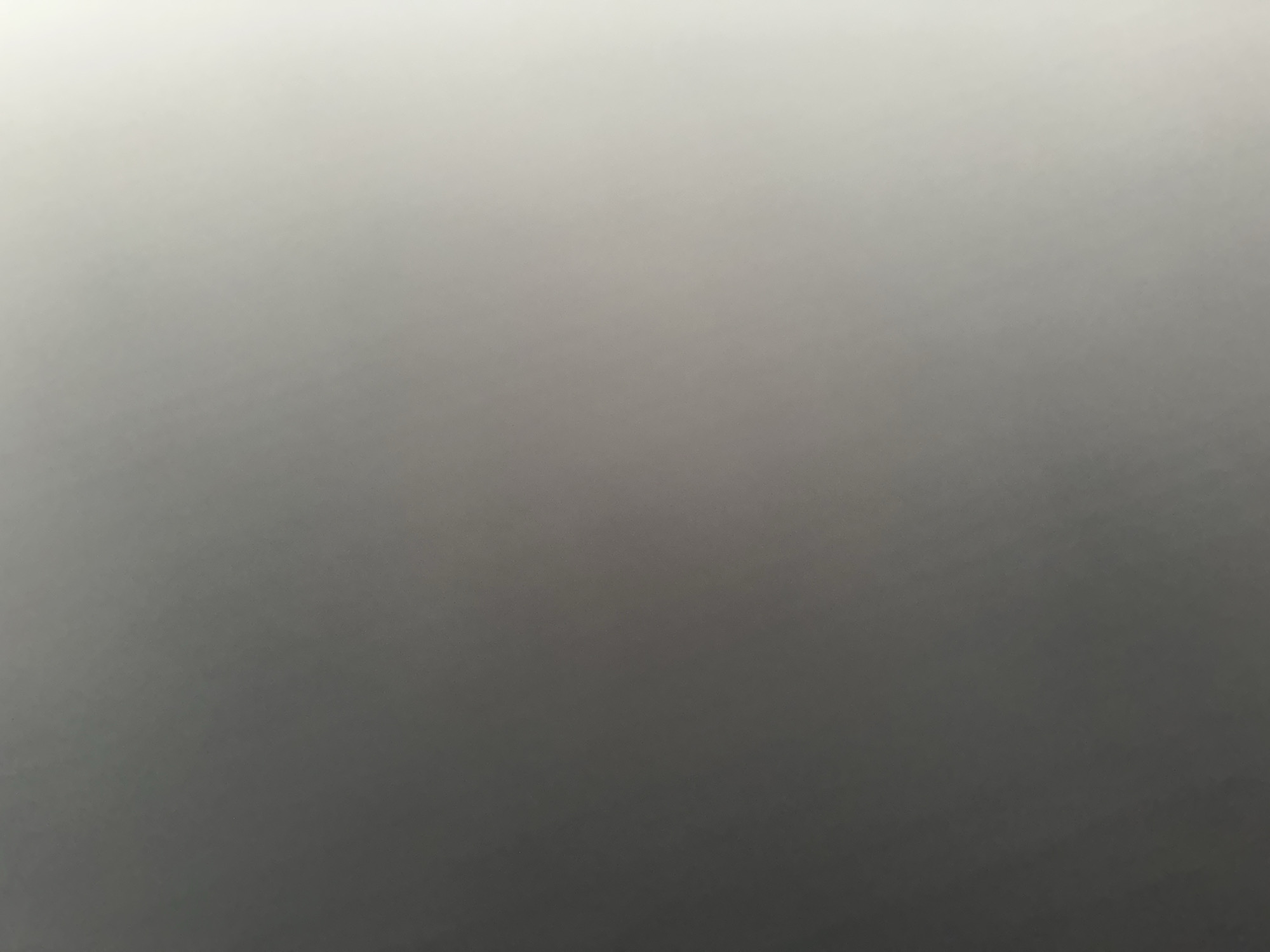 This is an abstract image with a gradient of light and shadow. There are no discernible people, subjects, objects, actions, interactions, or environmental features that would allow for the identification of a specific location in Belgrade, Serbia, or any other place. The image appears to be a close-up of a textured surface or a lens flare, with no discernible context.
