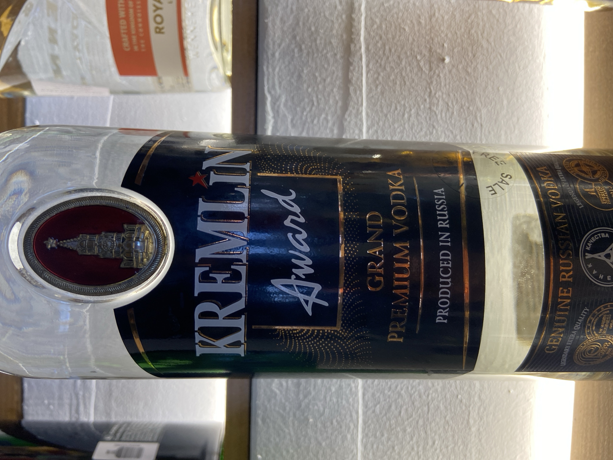 The image shows a bottle of Kremlin Award Grand Premium Vodka. The label indicates it is produced in Russia and is "genuine Russian vodka" with "legendary extra quality." The location is unknown. There are no people visible in the image.