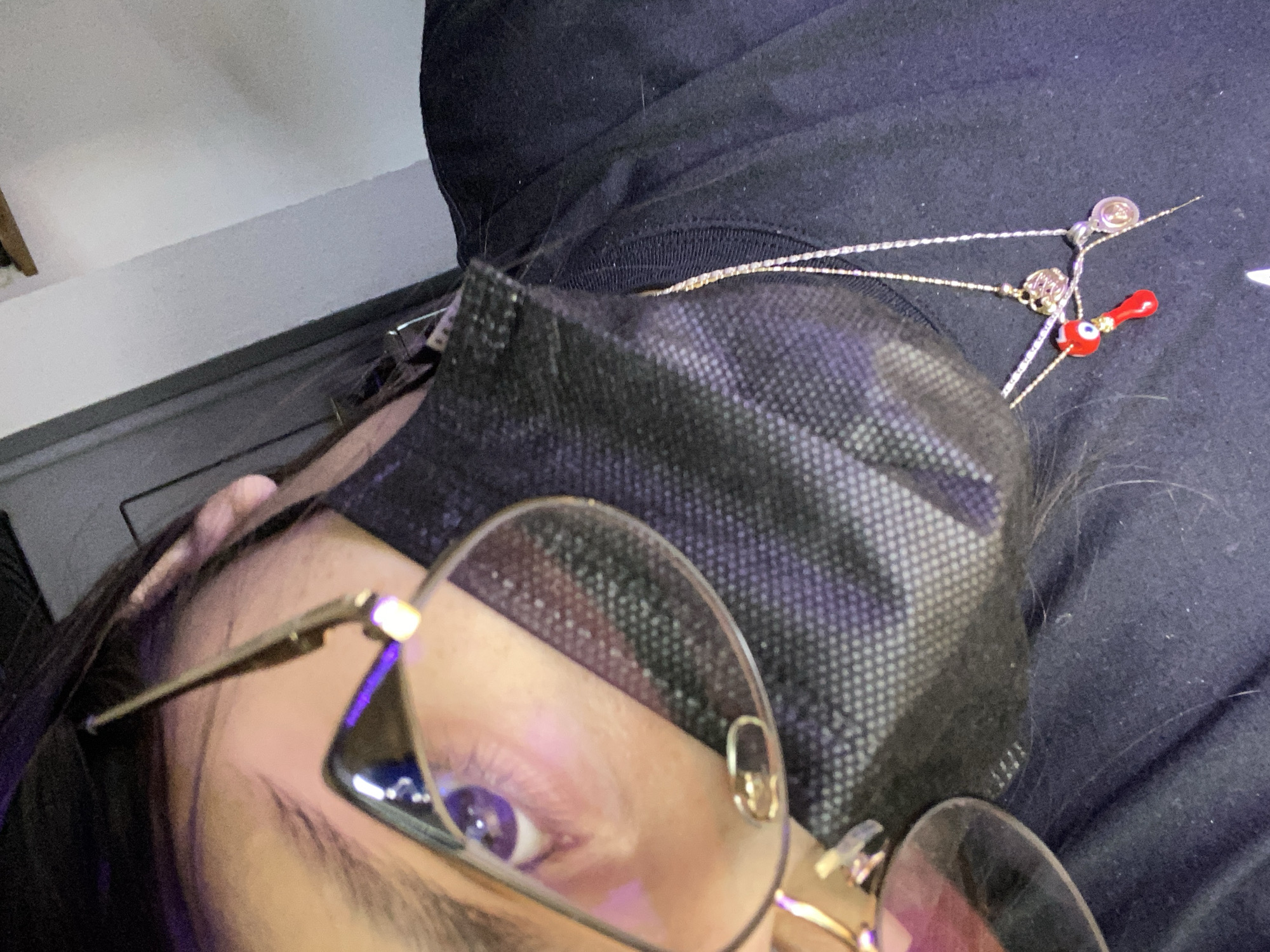 A close-up, selfie-style shot depicts a person wearing glasses and a black face mask. A gold chain necklace with small charms is visible on the person's chest. The background is dark and indistinct. There is no information to indicate the location is Cotoperíz, Venezuela.
