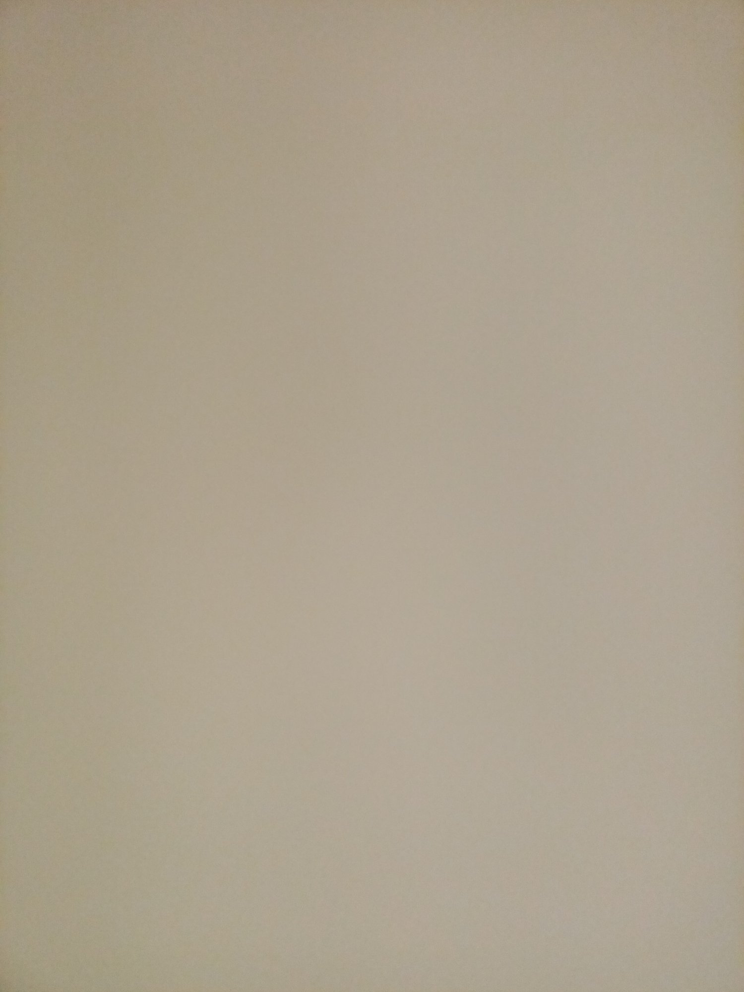 The image is a plain, uniformly colored background, appearing to be a wall or a large surface. The color is a muted, light beige or off-white, with subtle variations in shading that suggest soft lighting. There are no discernible objects, people, or architectural features present in the image. The scene is devoid of any activity or identifiable location within Rostov-on-Don, Russia.