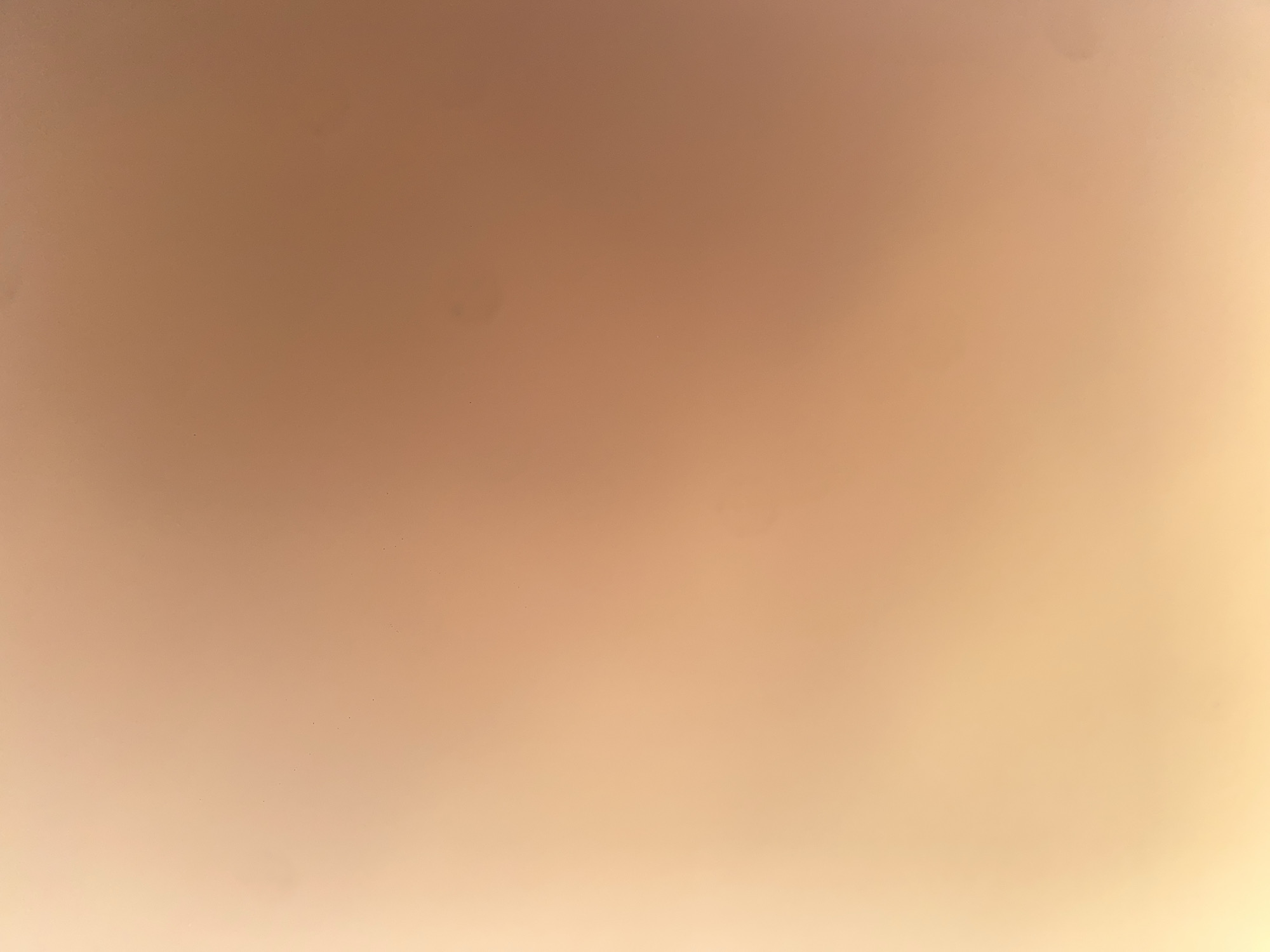 The image displays a blurry, abstract background with a gradient of warm, peachy-orange tones. There are no discernible objects, people, or environmental features visible. The lighting appears soft and diffused, creating a smooth, almost ethereal texture across the entire frame. The image is not suitable for providing details about the city of Ablanitsa, Bulgaria, as it contains no specific information related to that location.