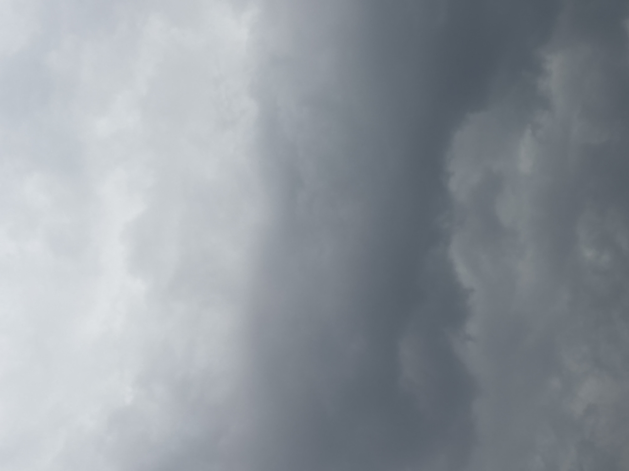 The image shows a sky filled with dark, ominous storm clouds. The clouds are various shades of gray, with darker patches indicating areas of greater density. The light is diffused, suggesting an overcast or stormy atmosphere. The image does not provide information that is specific enough to determine the location as Puebla, Mexico. No people, subjects, objects, actions, or interactions are apparent in the picture.