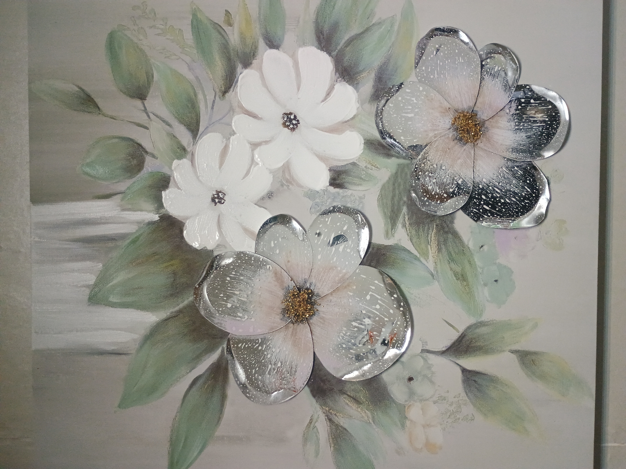 The image shows a painting or print of flowers with decorative elements. There are two white flowers with dark centers and two flowers with reflective, silver-colored petals and golden centers. The flowers are surrounded by green and light green leaves against a muted beige or grey background. Some brushstrokes and painting techniques are visible in the background and on the leaves.