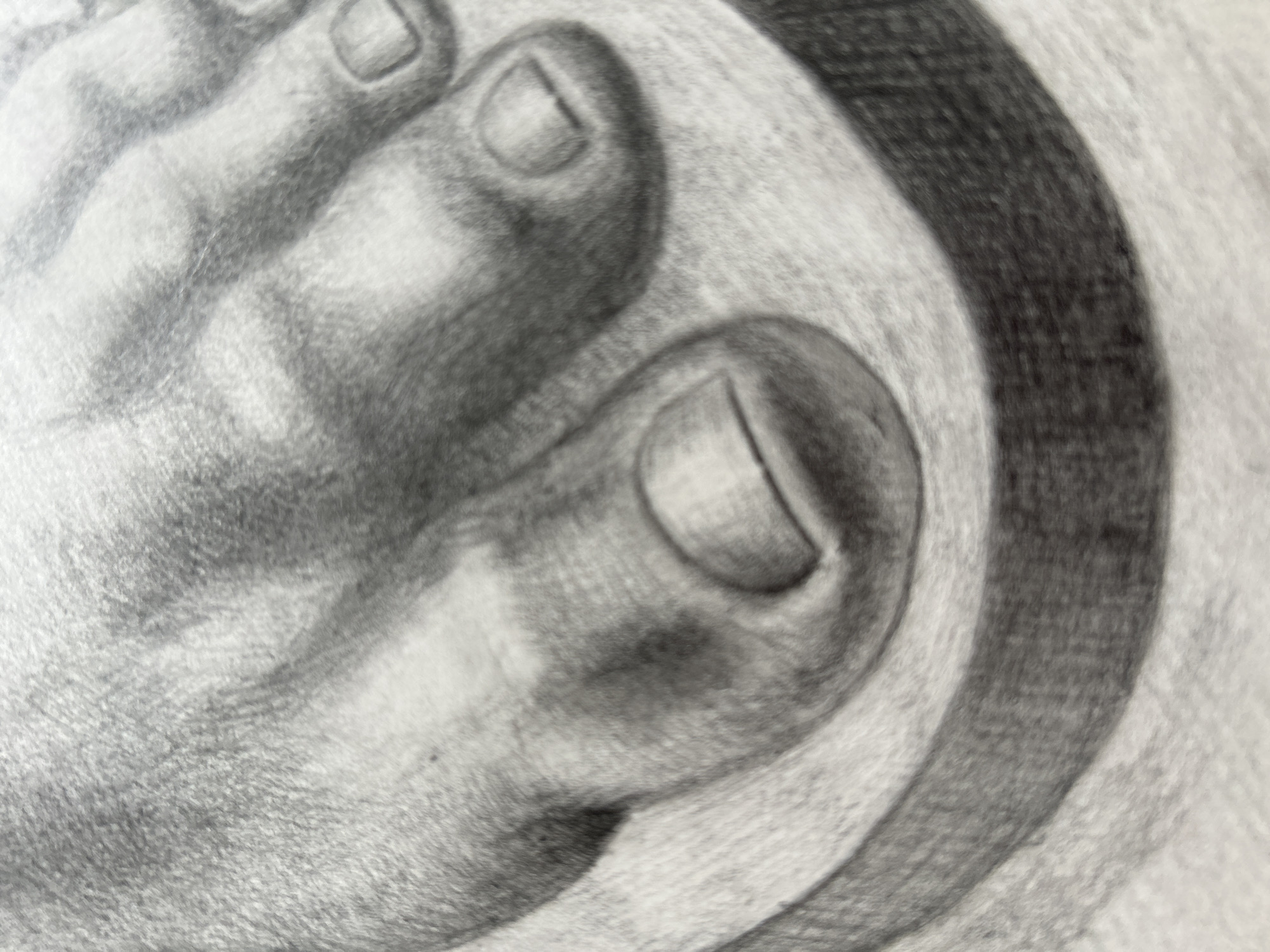 This is a close-up, black and white pencil drawing of a human foot, with a focus on the toes. The drawing captures the texture of the skin and the shape of the toenails with subtle shading. The foot appears to be resting on a circular, raised object, which is also rendered with shading to give it form. The background is a light, textured surface, likely the paper on which the drawing was created. There is no discernible location in Moscow, Russia, or any other real-world environment depicted.