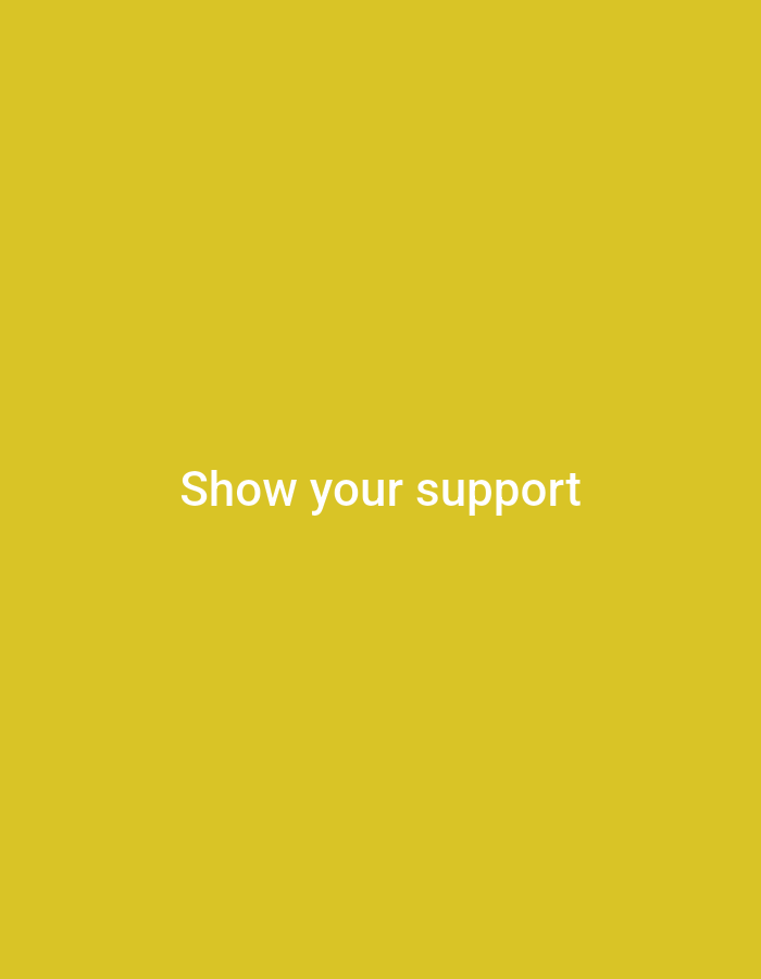 The image is a plain yellow background with white text centered on it. The text reads "Show your support". There are no other discernible subjects, objects, activities, or events depicted. The background is a solid color with no visible details regarding time of day, weather, location, or emotions. The image is a simple text graphic.